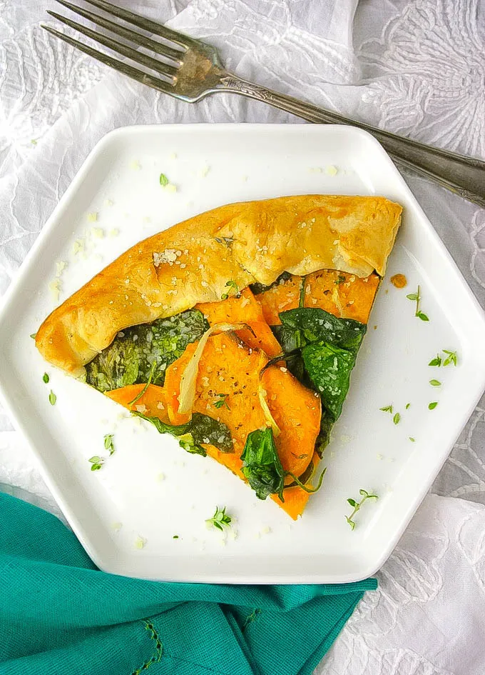 A slice of this delicious Sweet Potato and Spinach Galette will have you convinced this meatless dish is delicious! Sweet Potato and Spinach Galette makes a wonderful vegetarian dish for any day.