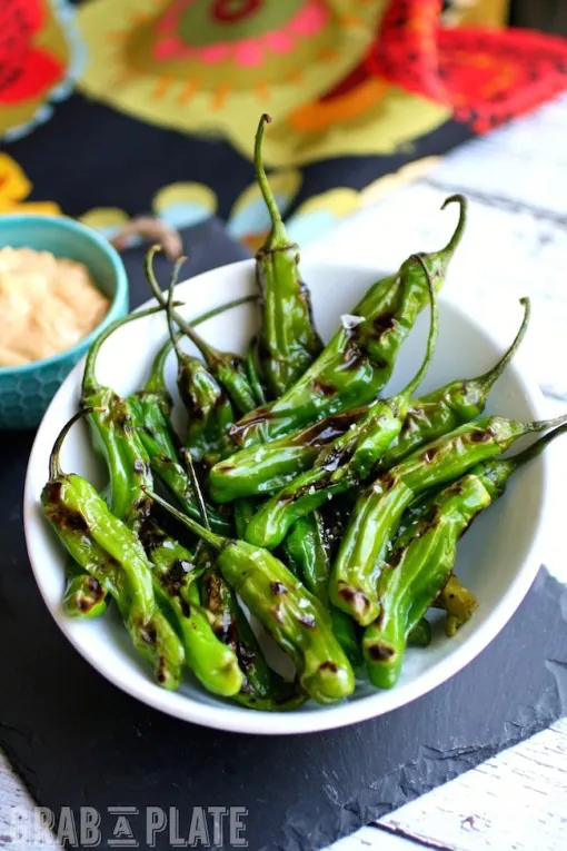 Indulge in an easy-to-make appetizer: Blistered Shishito Peppers with Smoky Paprika Aioli