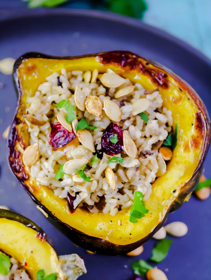 Acorn Squash Stuffed with Brown Rice, Mushrooms, and Cranberries is such a pretty dish to serve for a special meal. Acorn Squash Stuffed with Brown Rice, Mushrooms, and Cranberries is easy to make and fun to serve.