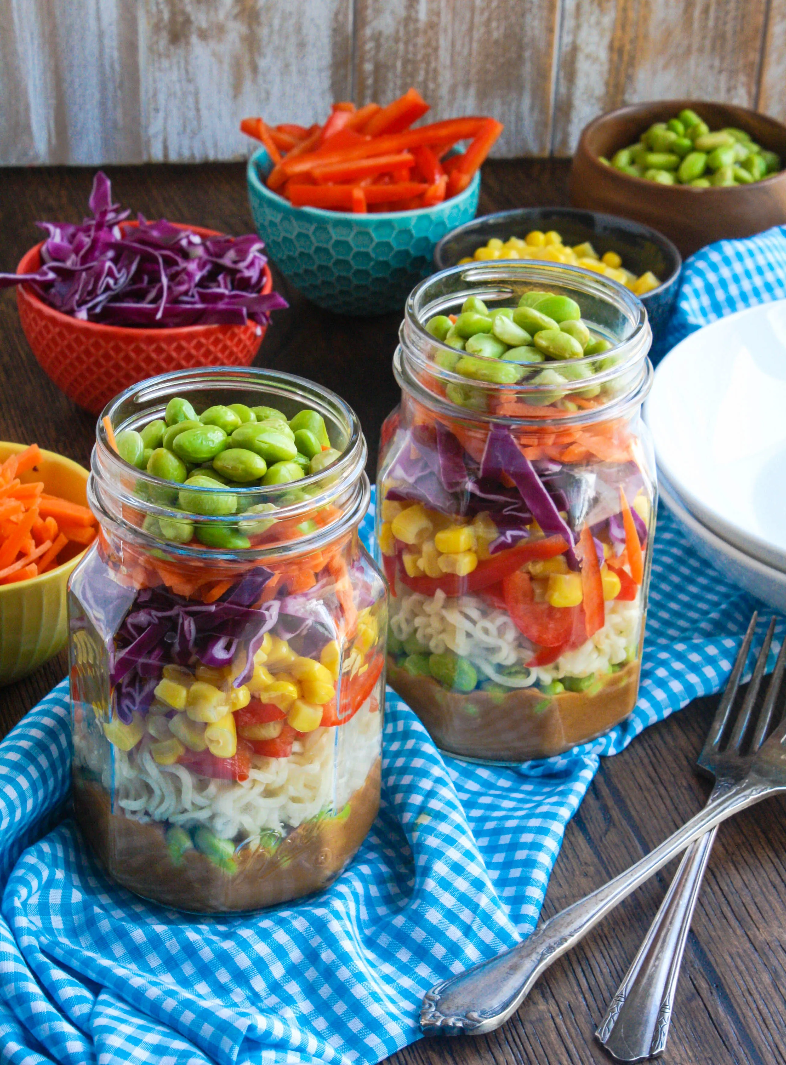 Asian Noodle Salad in a Jar with Spicy Peanut Dressing is a fun way to serve your next salad. It's totally delicious, too!