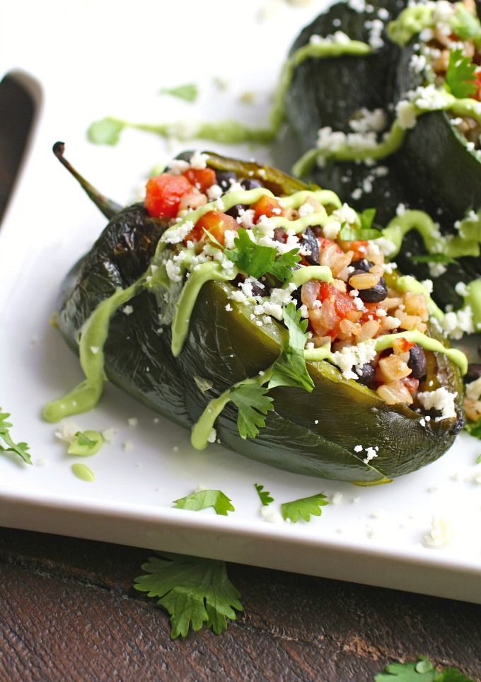 Black Bean and Rice Stuffed Poblano Peppers with Avocado Cream are warm and filling, and a great meatless dish.