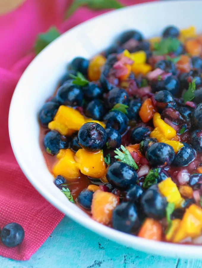 Blueberry-Mango Salsa is a snack you'll want to dig into over and over again this season! Blueberry-Mango Salsa is a tasty and easy snack for the season.