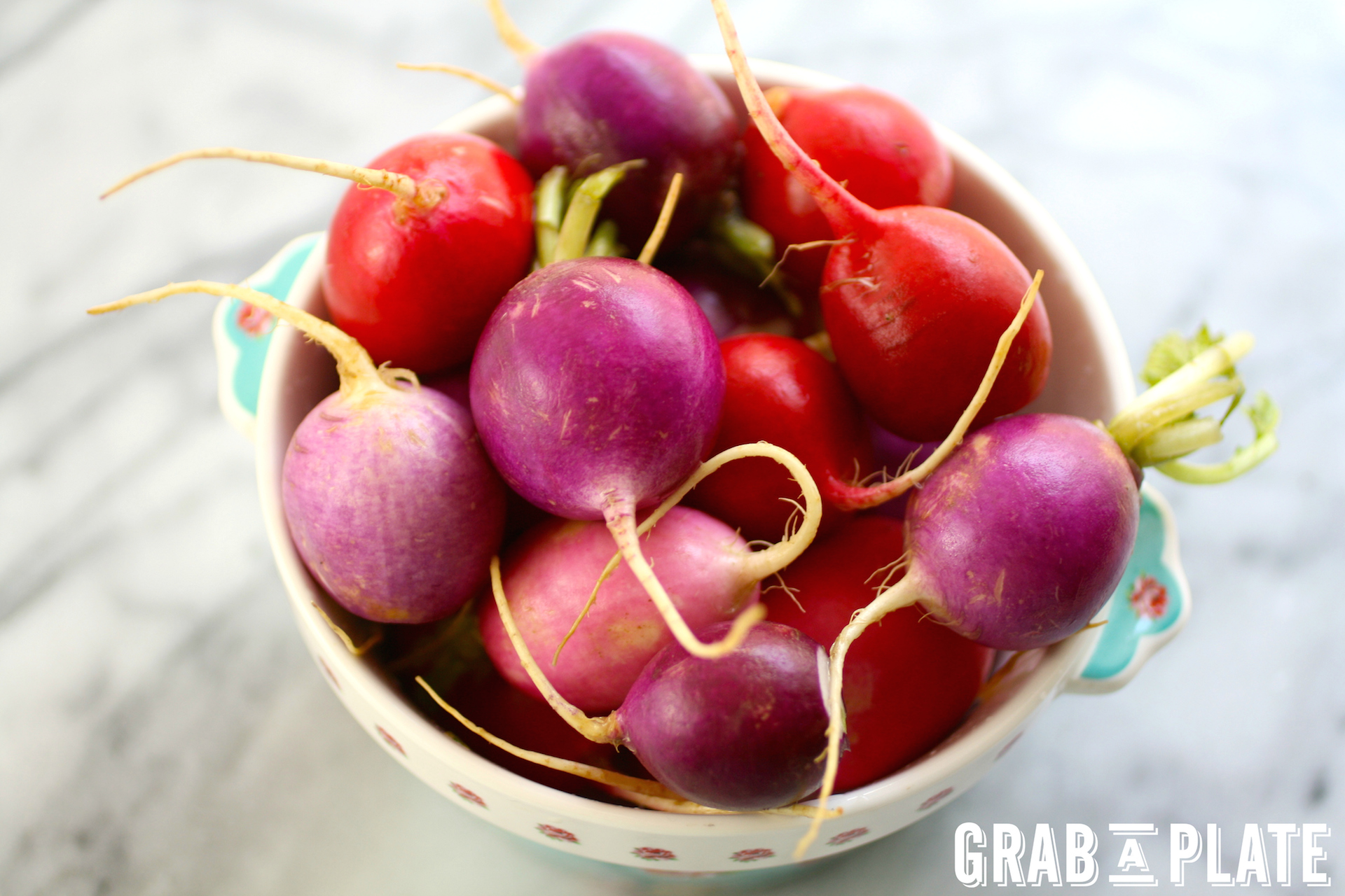 A bowl of colorful radishes