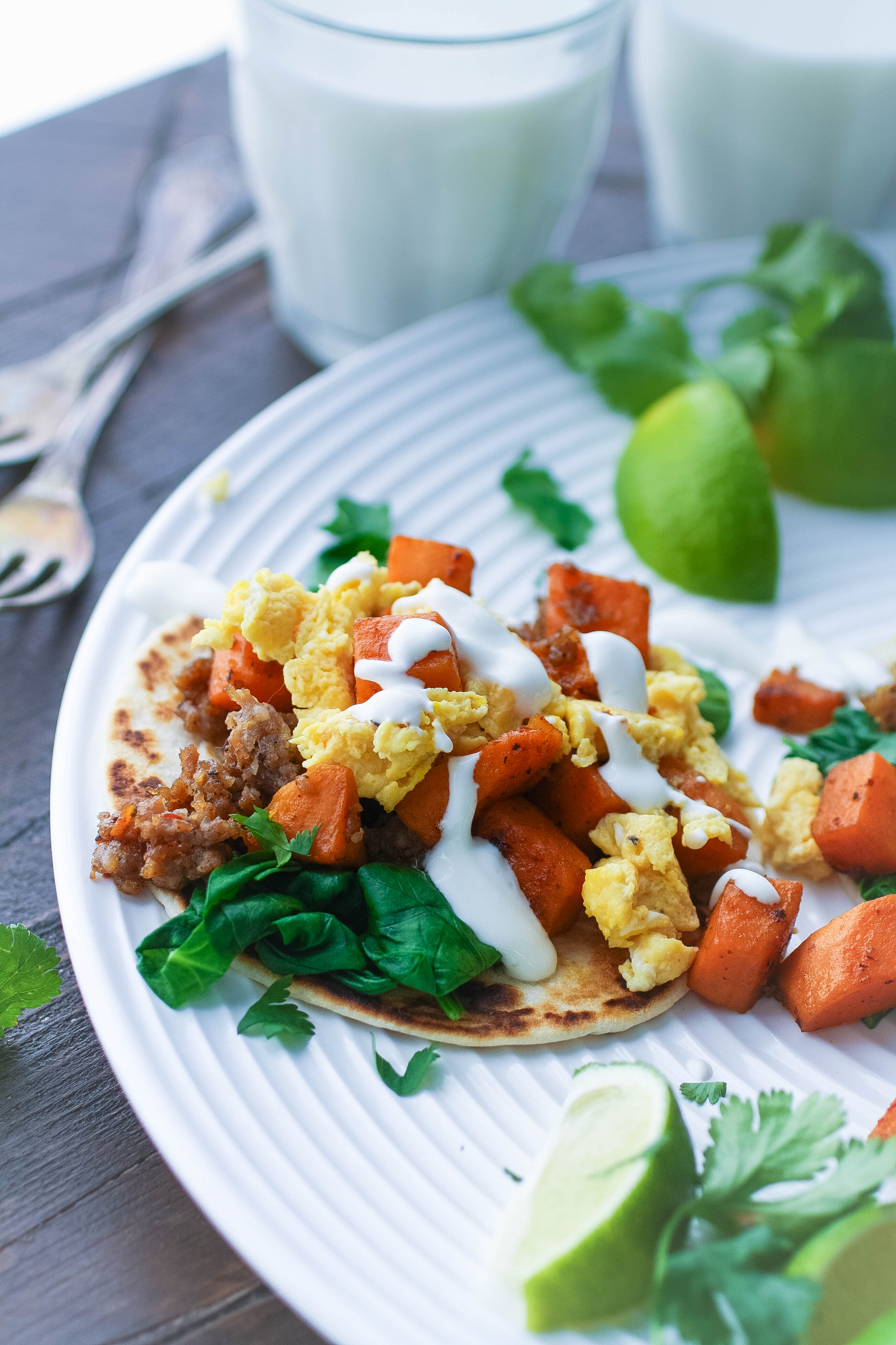 Breakfast Tacos with Sweet Potatoes, Sausage, Spinach, and Lime Crema are tasty tacos, for sure! Make these Breakfast Tacos with Sweet Potatoes, Sausage, Spinach, and Lime Crema for any meal of the day.