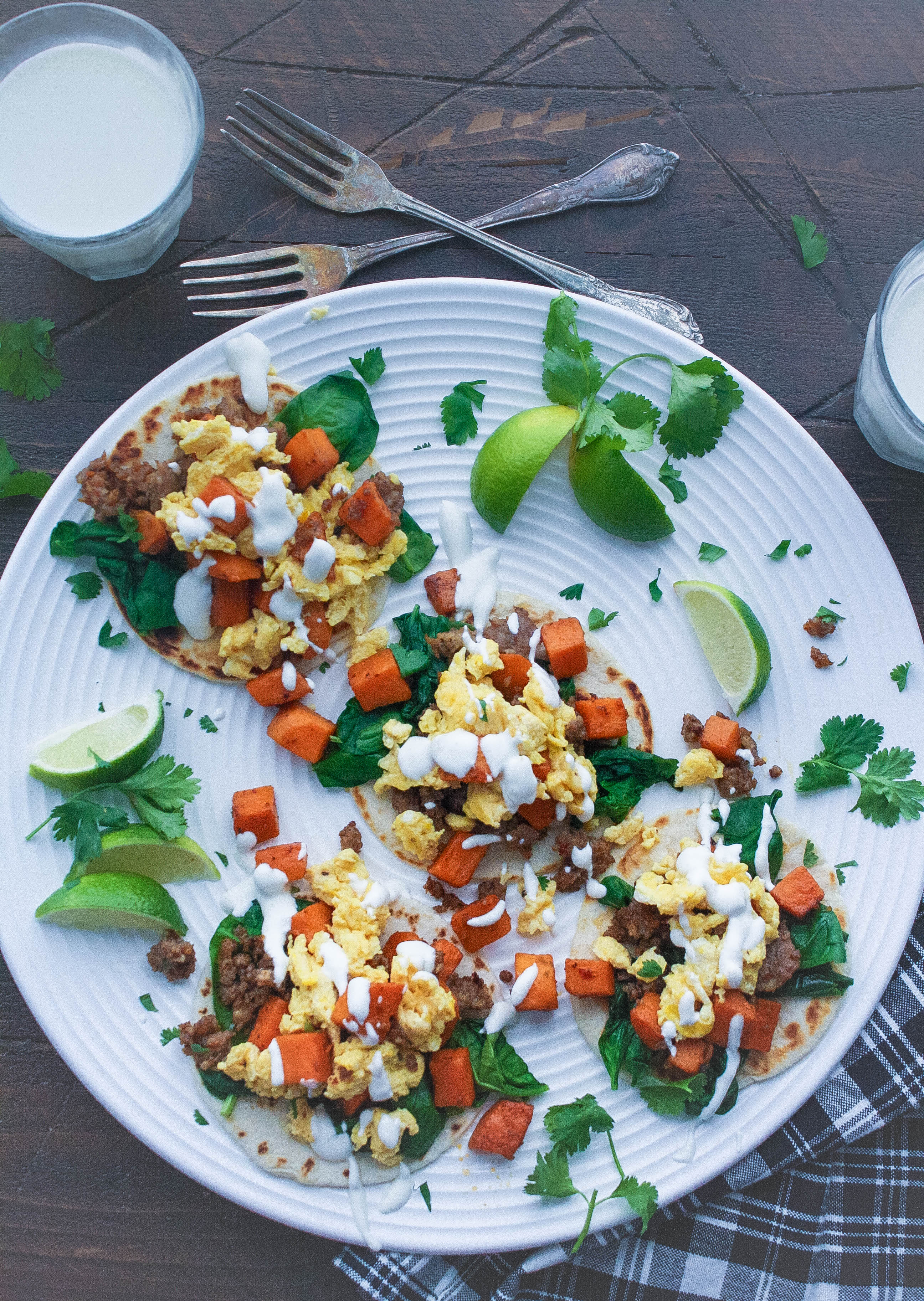 Breakfast Tacos with Sweet Potatoes, Sausage, Spinach, and Lime Crema are delightful! Try Breakfast Tacos with Sweet Potatoes, Sausage, Spinach, and Lime Crema soon!