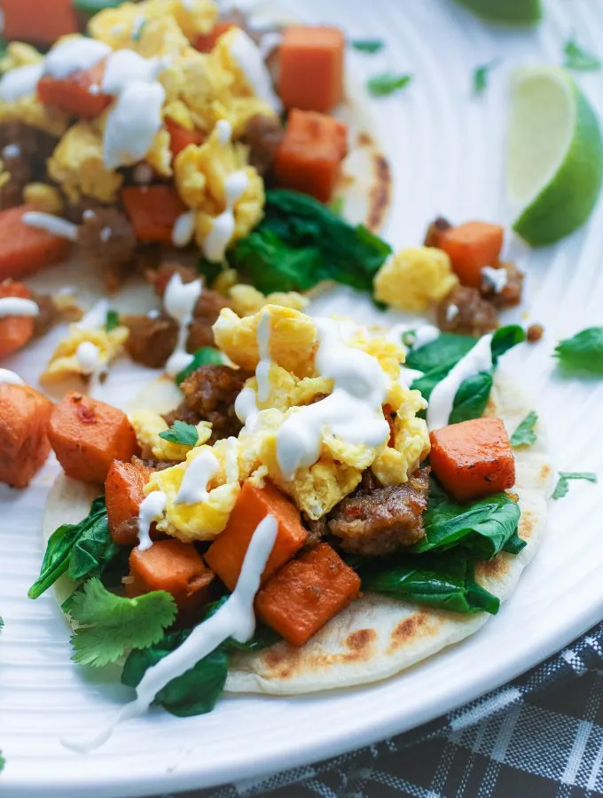 Breakfast Tacos with Sweet Potatoes, Sausage, Spinach, and Lime Crema are so fun to serve early in the day. Breakfast Tacos with Sweet Potatoes, Sausage, Spinach, and Lime Crema are fun for breakfast or brunch!