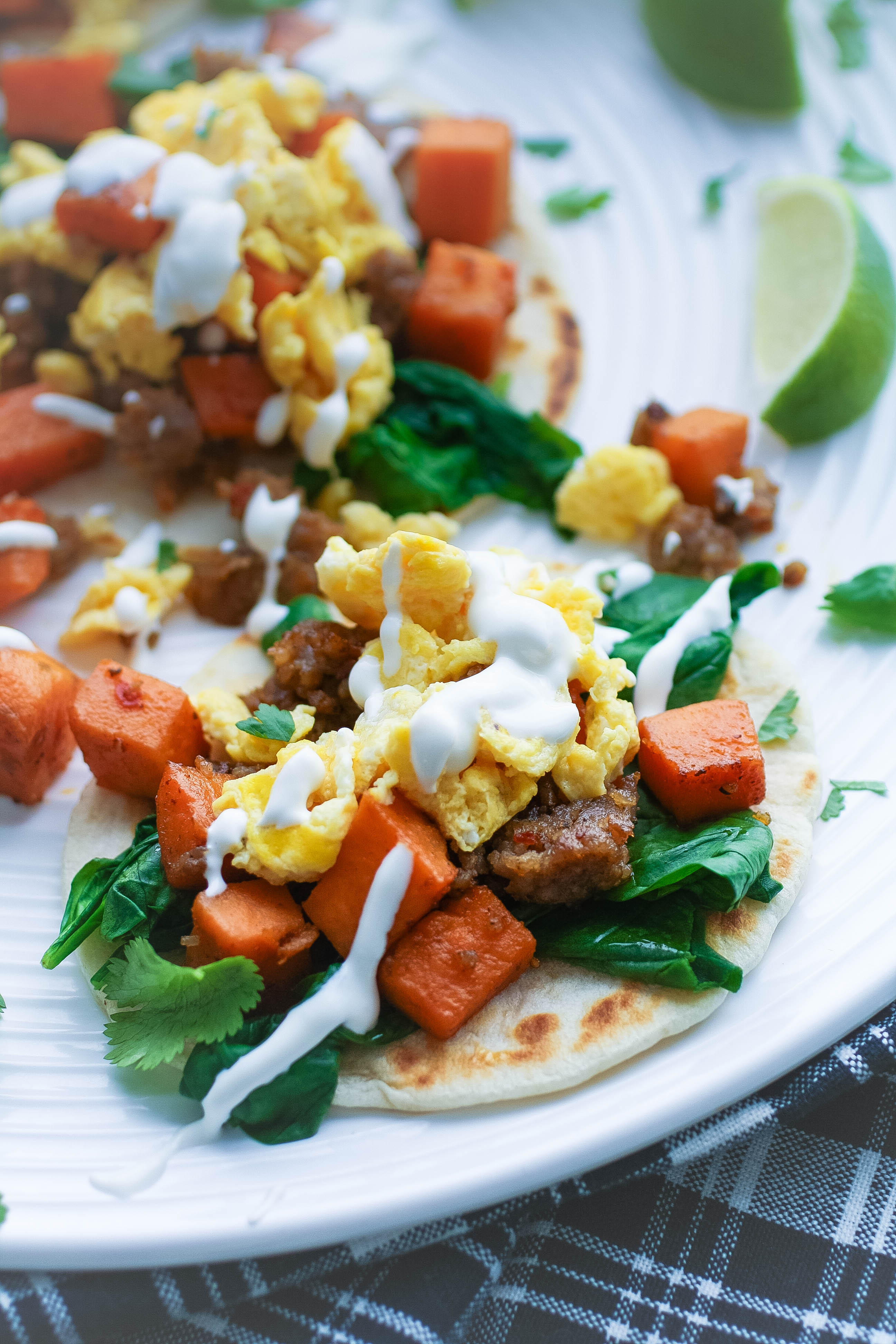 Breakfast Tacos with Sweet Potatoes, Sausage, Spinach, and Lime Crema are so fun to serve early in the day. Breakfast Tacos with Sweet Potatoes, Sausage, Spinach, and Lime Crema are fun for breakfast or brunch!