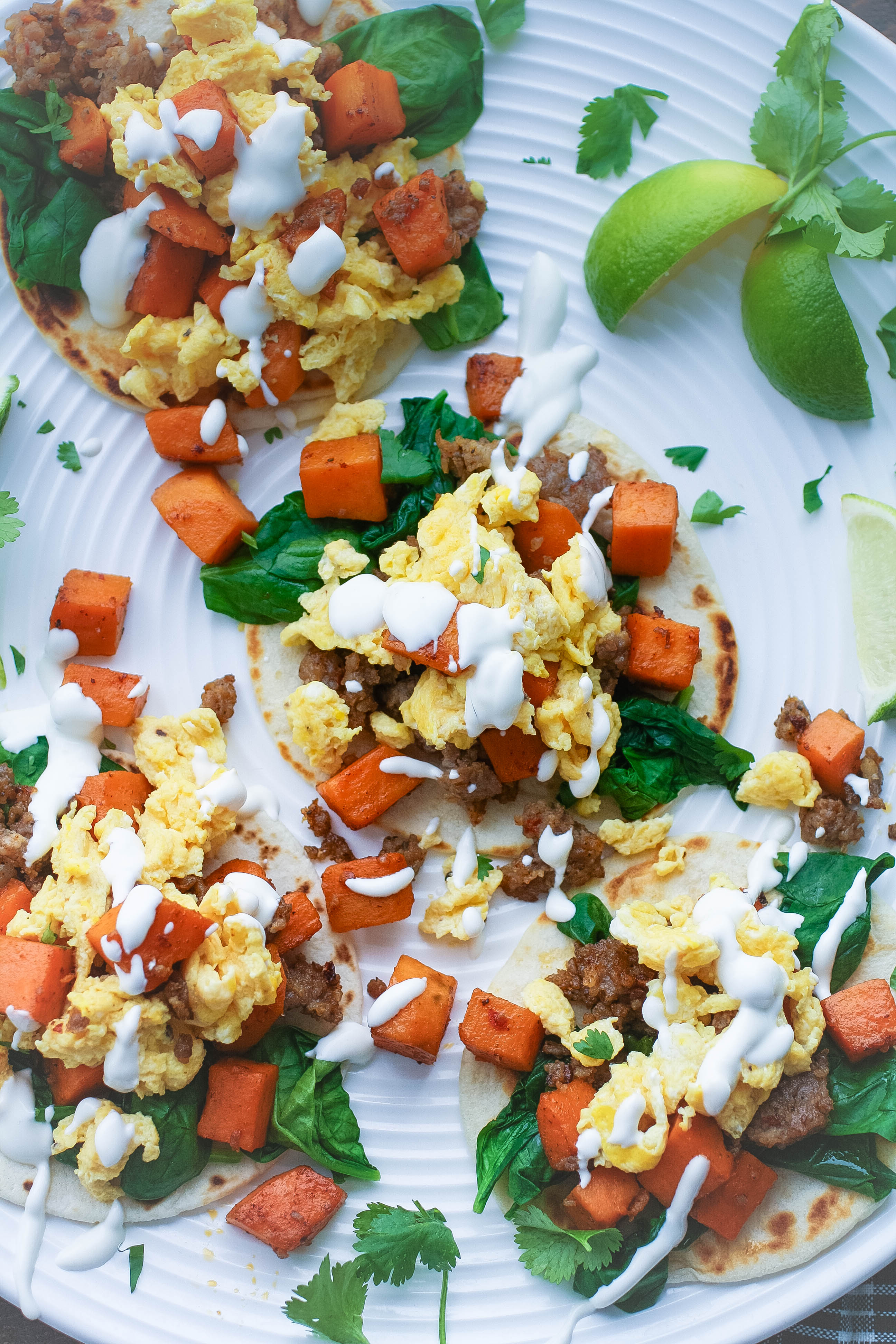 Breakfast Tacos with Sweet Potatoes, Sausage, Spinach, and Lime Crema make a fabulous meal! Breakfast Tacos with Sweet Potatoes, Sausage, Spinach, and Lime Crema are tasty and they make a fun meal!