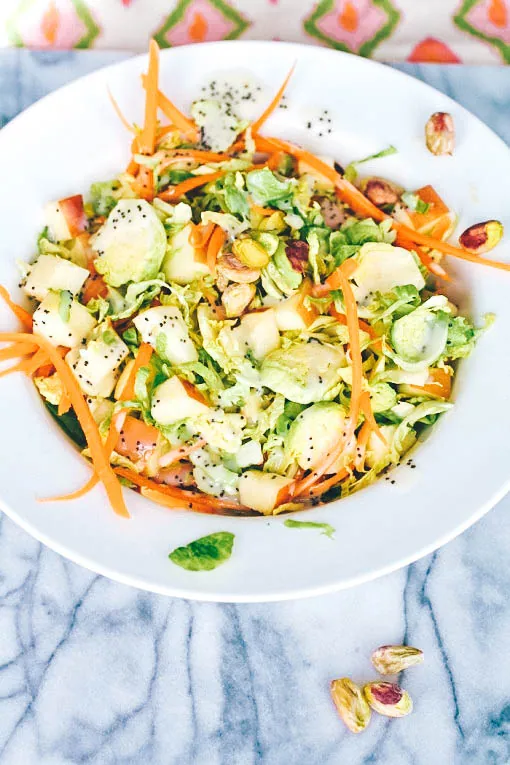 Brussels Sprouts Salad with Carrots, Apples, Pistachios & Poppy Seed Dressing is a delight for the season! Whip up a Brussels Sprouts Salad with Carrots, Apples, Pistachios & Poppy Seed Dressing tonight!
