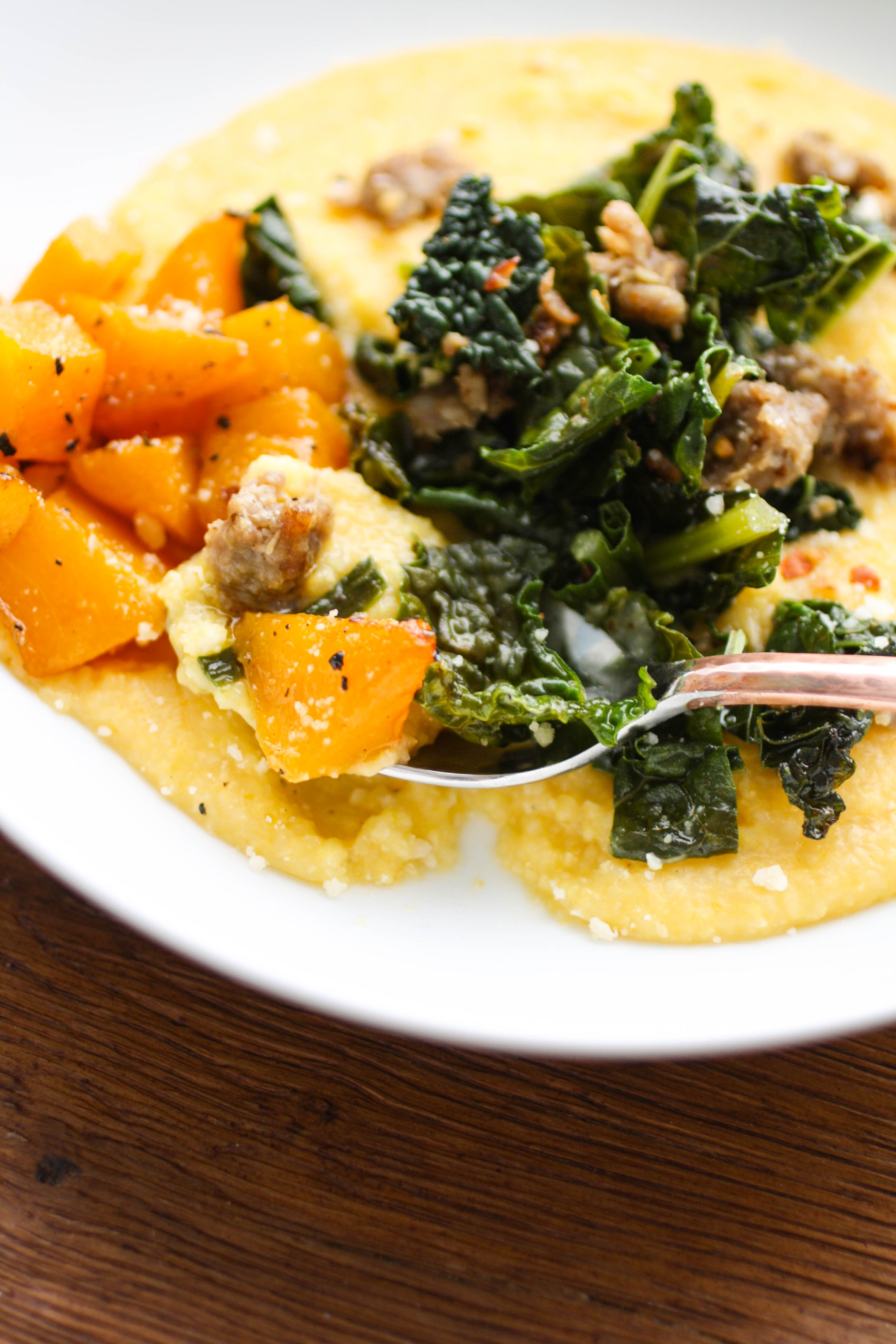Butternut Squash Grits with Sausage and Kale is a warming and flavorful dish on a cold night. You'll want to scoop up spoonful after spoonful of these grits.