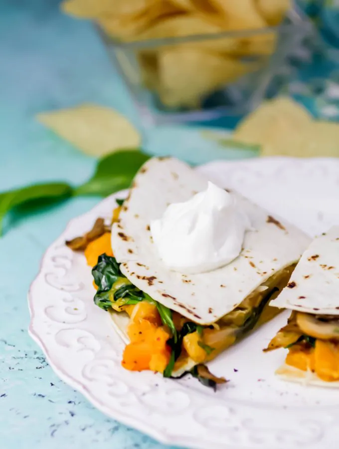 Butternut Squash, Mushroom, Onion, and Spinach Quesadillas make a simple, delicious meal. Butternut Squash, Mushroom, Onion, and Spinach Quesadillas are great as a meatless dish -- you won't miss the meat!