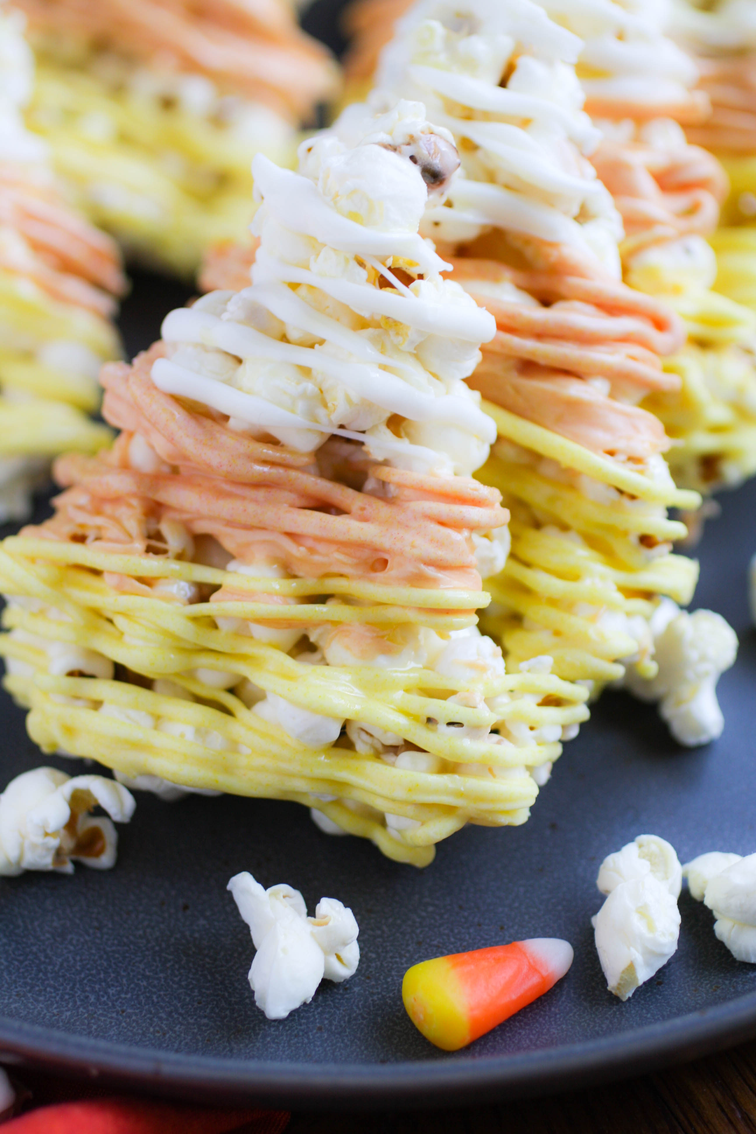 Candy Corn-Shaped Popcorn Balls make a festive treat for Halloween! This season, make a batch of Candy Corn-Shaped Popcorn Balls!