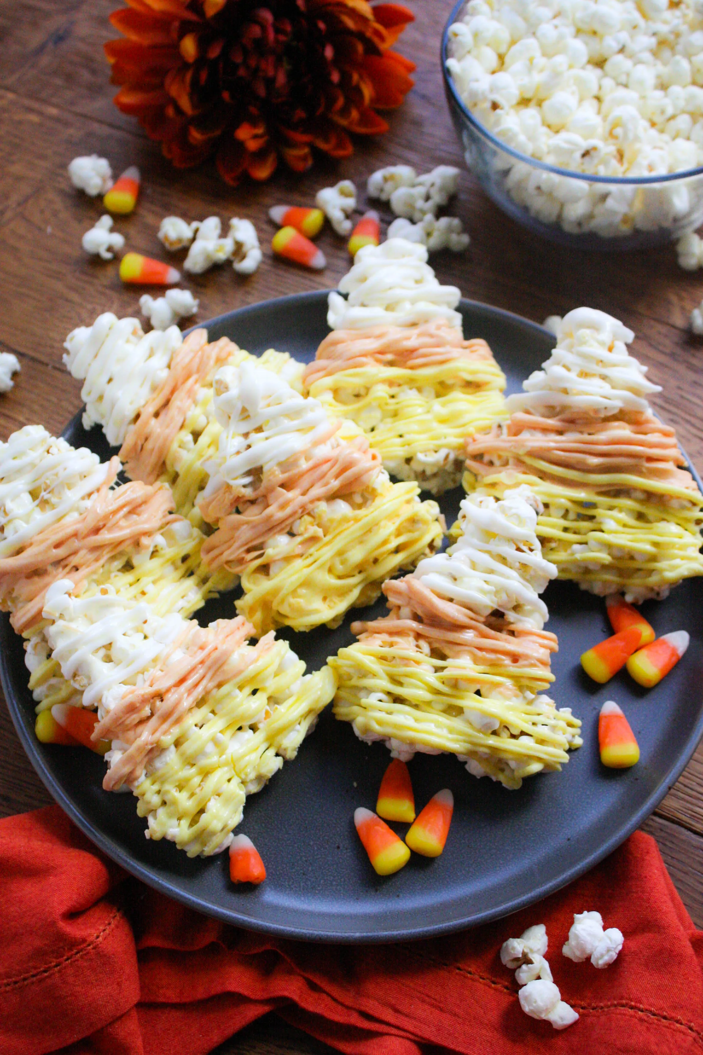 Candy Corn-Shaped Popcorn Balls are festive and fabulous for Halloween! Make these Candy Corn-Shaped Popcorn Balls for a Halloween treat! 