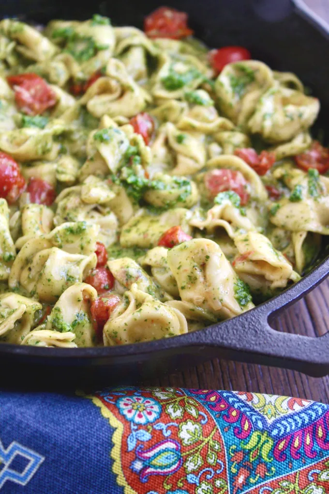 Creamy Skillet Tortellini with Arugula Pesto is a filling and colorful dish! This meatless dish is so easy to make, too!