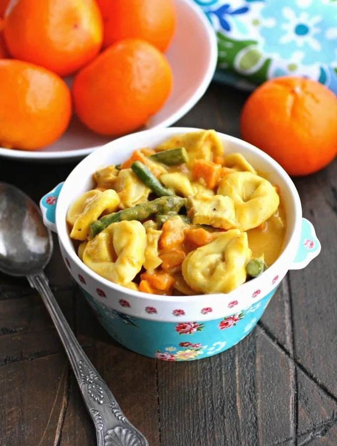 Enjoy a bowl of Creamy Curried Veggie & Chicken Tortellini Soup for a hearty and flavorful meal!