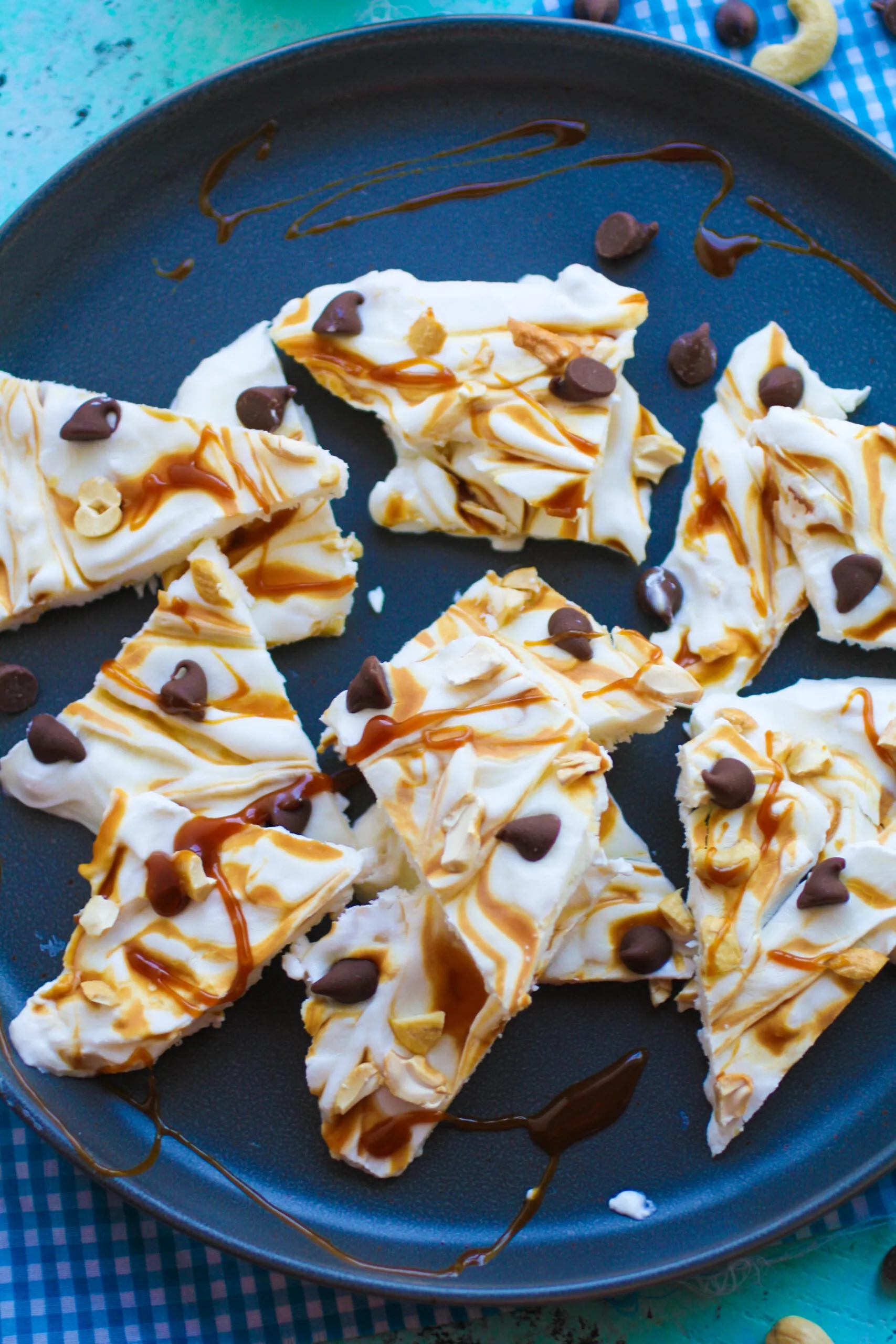 Frozen Yogurt Bark with Caramel, Cashews and Chocolate are piled high for you to enjoy for a frozen dessert!