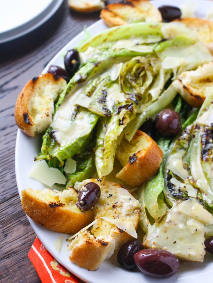 Grilled Romaine Salad with Caesar Dressing is a deliciously different salad you'll love. Make this any time of year!