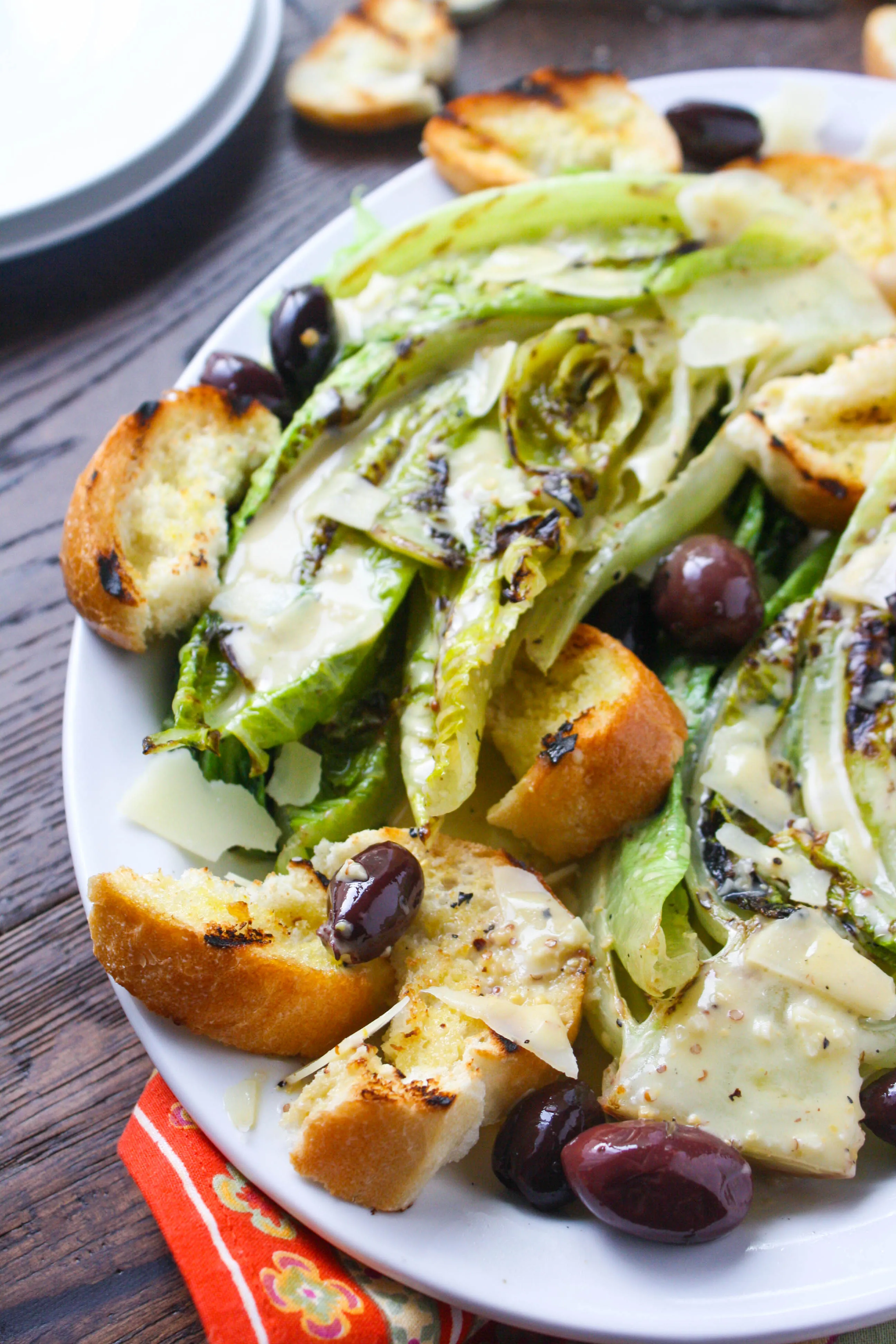 Grilled Romaine Salad with Caesar Dressing is a deliciously different salad you'll love. Make this any time of year!