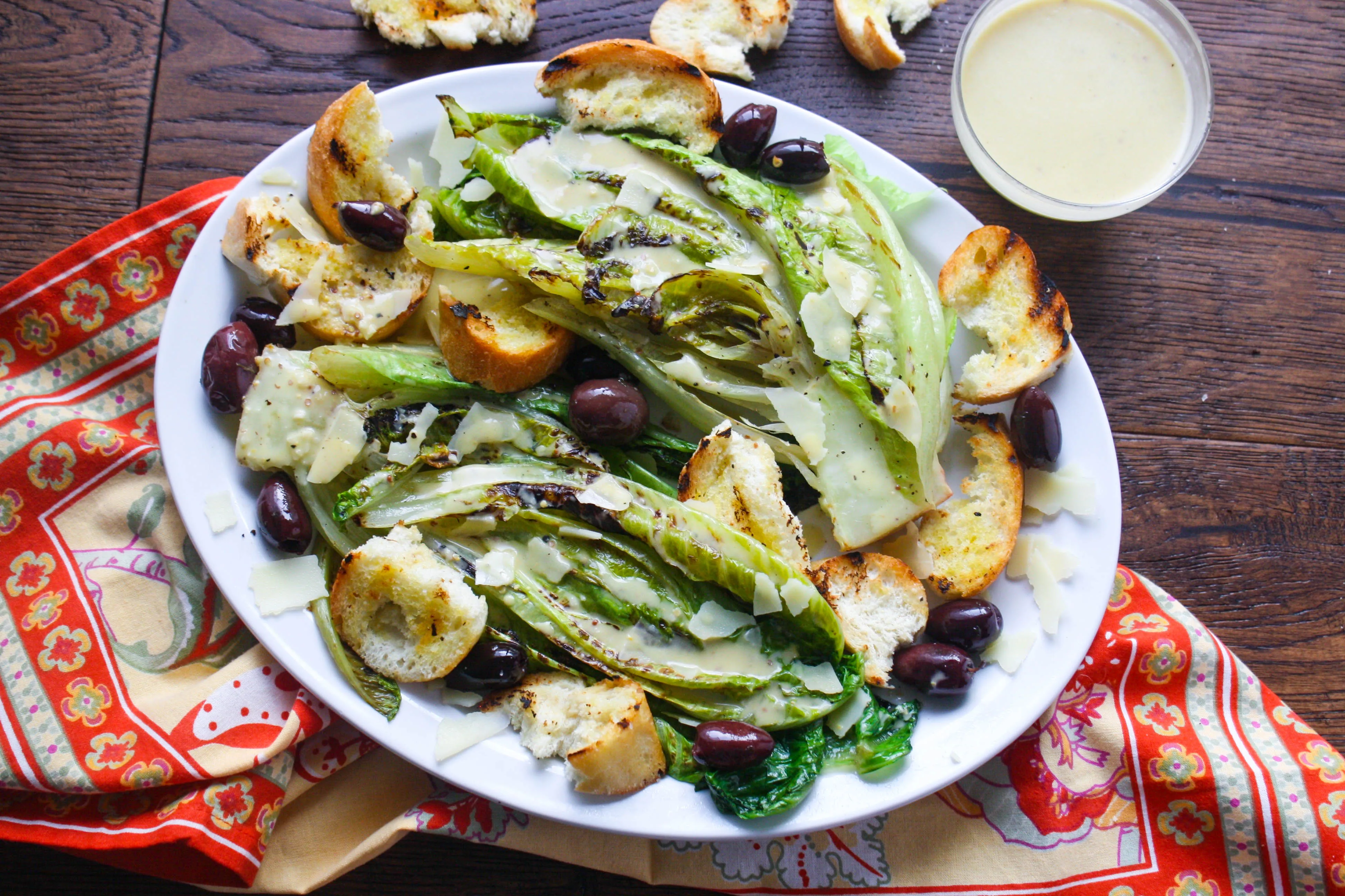 Grilled Romaine Salad with Caesar Dressing is a fun way to serve your salad. It's grilled for added flavor.