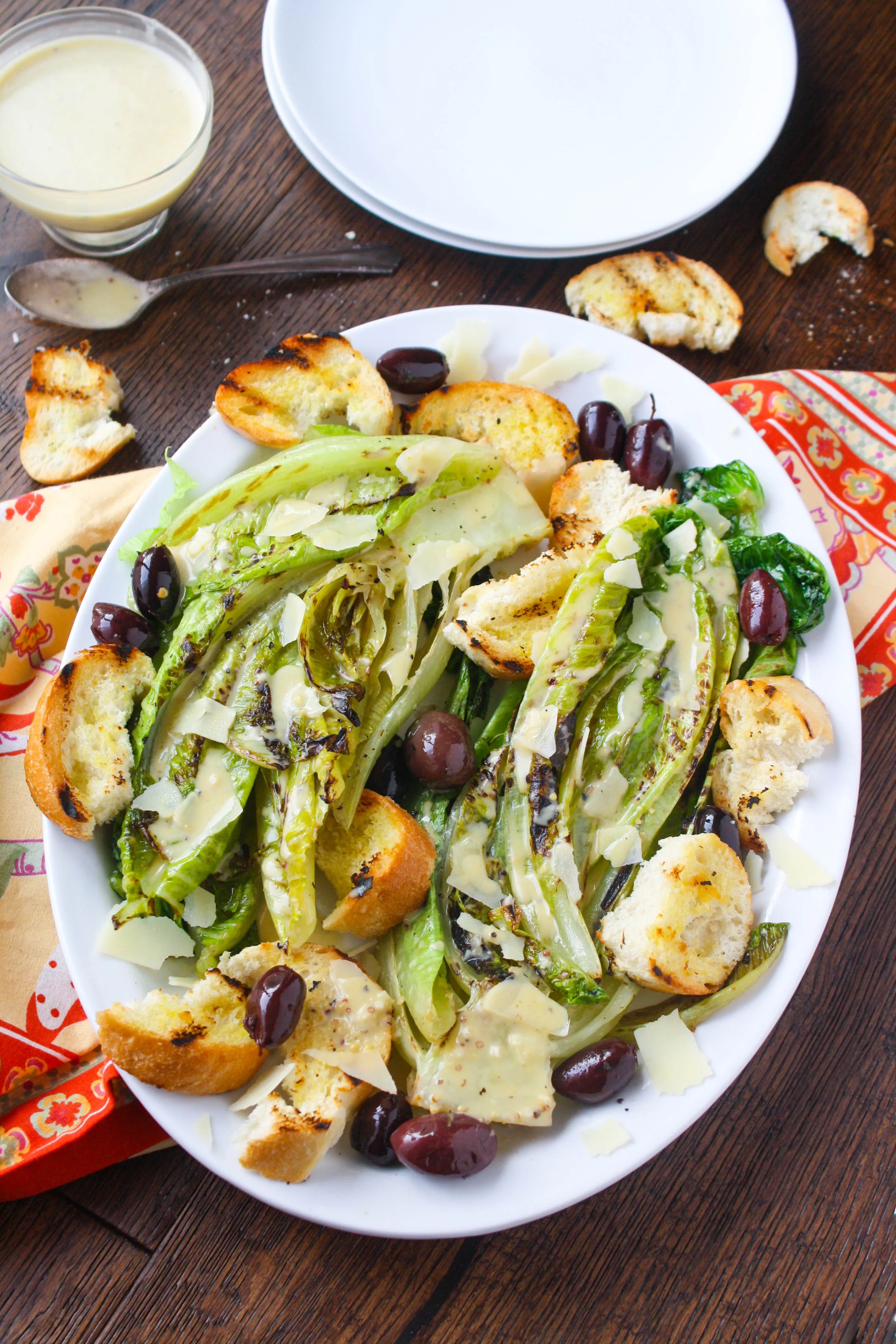 Grilled Romaine Salad with Caesar Dressing is a fun salad any time of year. You'll love the flavor grilling adds, and the dressing is delicious (with no egg included)!