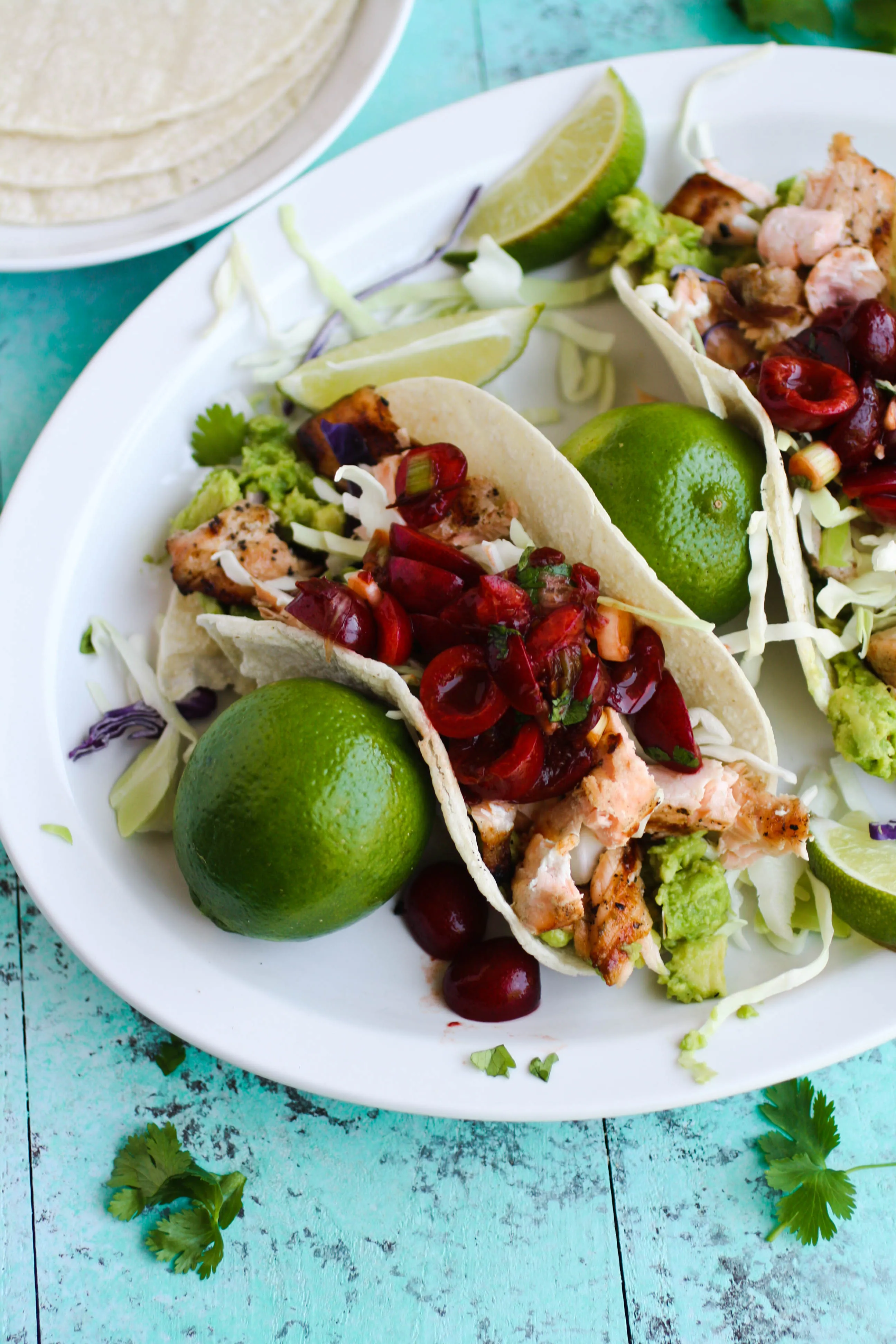 Grilled Salmon Tacos with Fresh Cherry-Chipotle Salsa is the perfect summer-season dish! You'll love to crack open the grill for these tacos!