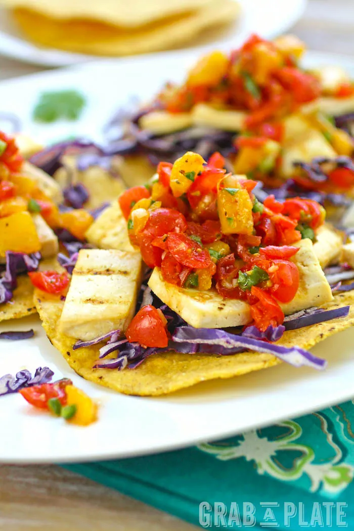 Grilled Tofu Tostadas with Tomato-Mango Salsa are deliciuos any day of the year. They're both meatless and flavorful!