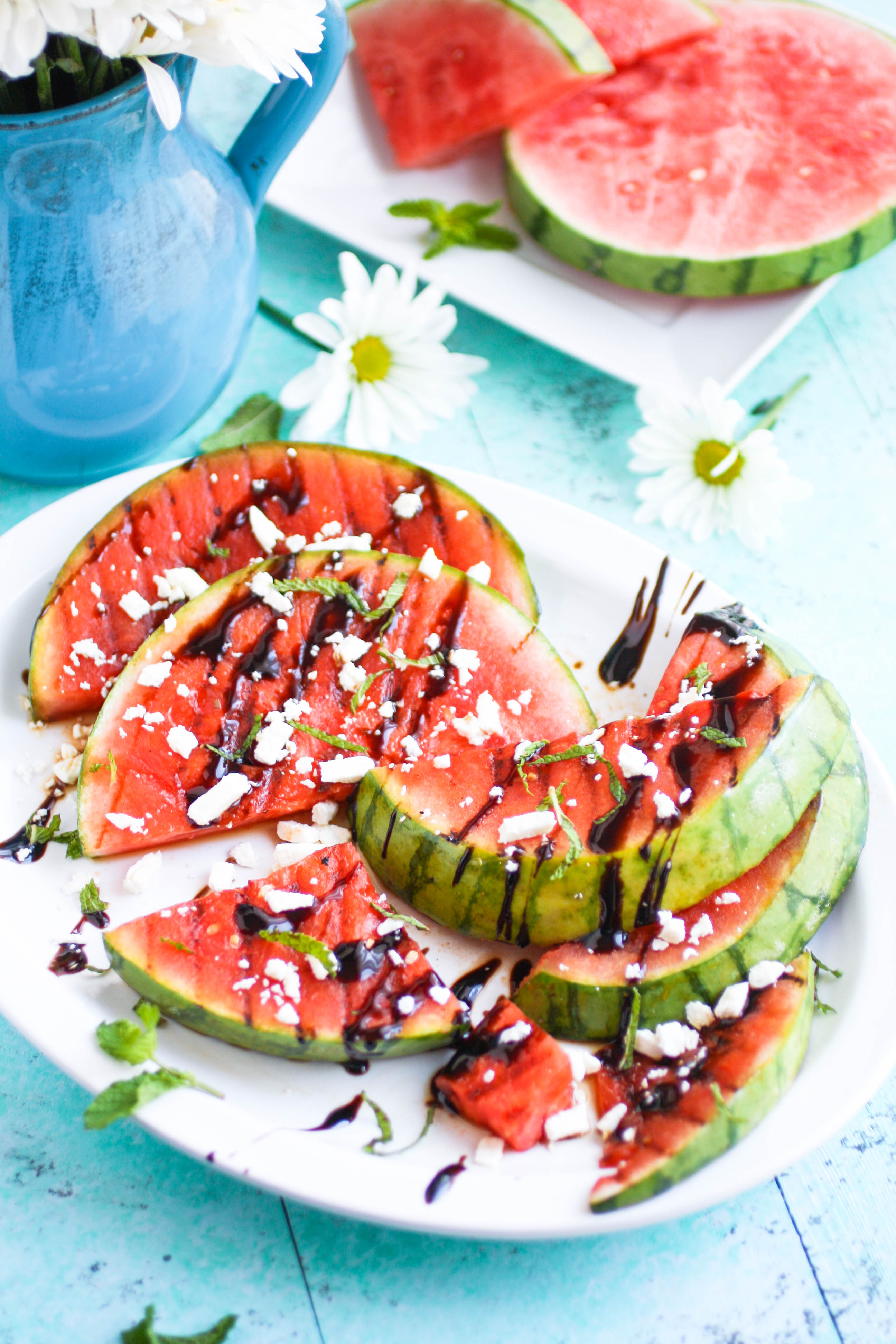 Grilled Watermelon with Feta, Mint, and Balsamic Glaze makes a fresh and fruity appetizer. Grilled Watermelon with Feta, Mint, and Balsamic Glaze is a fun appetizer to make this summer.