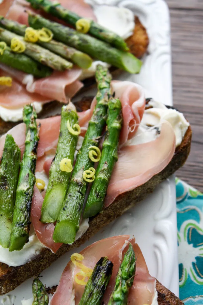 Grilled Asparagus, Prosciutto, and Brie Bruschetta is a tasty snack. Try it at your next gathering!