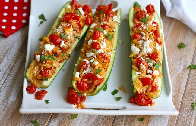 Zucchini stuffed with herbed orzo, almonds, and fresh tomato sauce