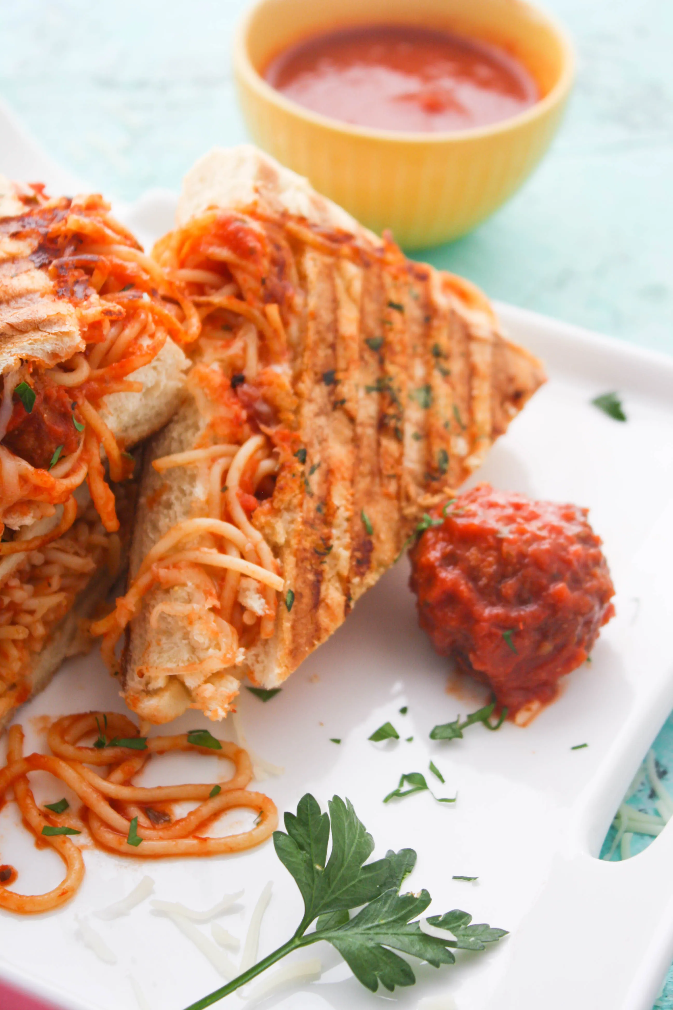 Leftover Spaghetti & Meatball Panini is a great dish to use up last night's meal! You'll love how fun this sandwich is!