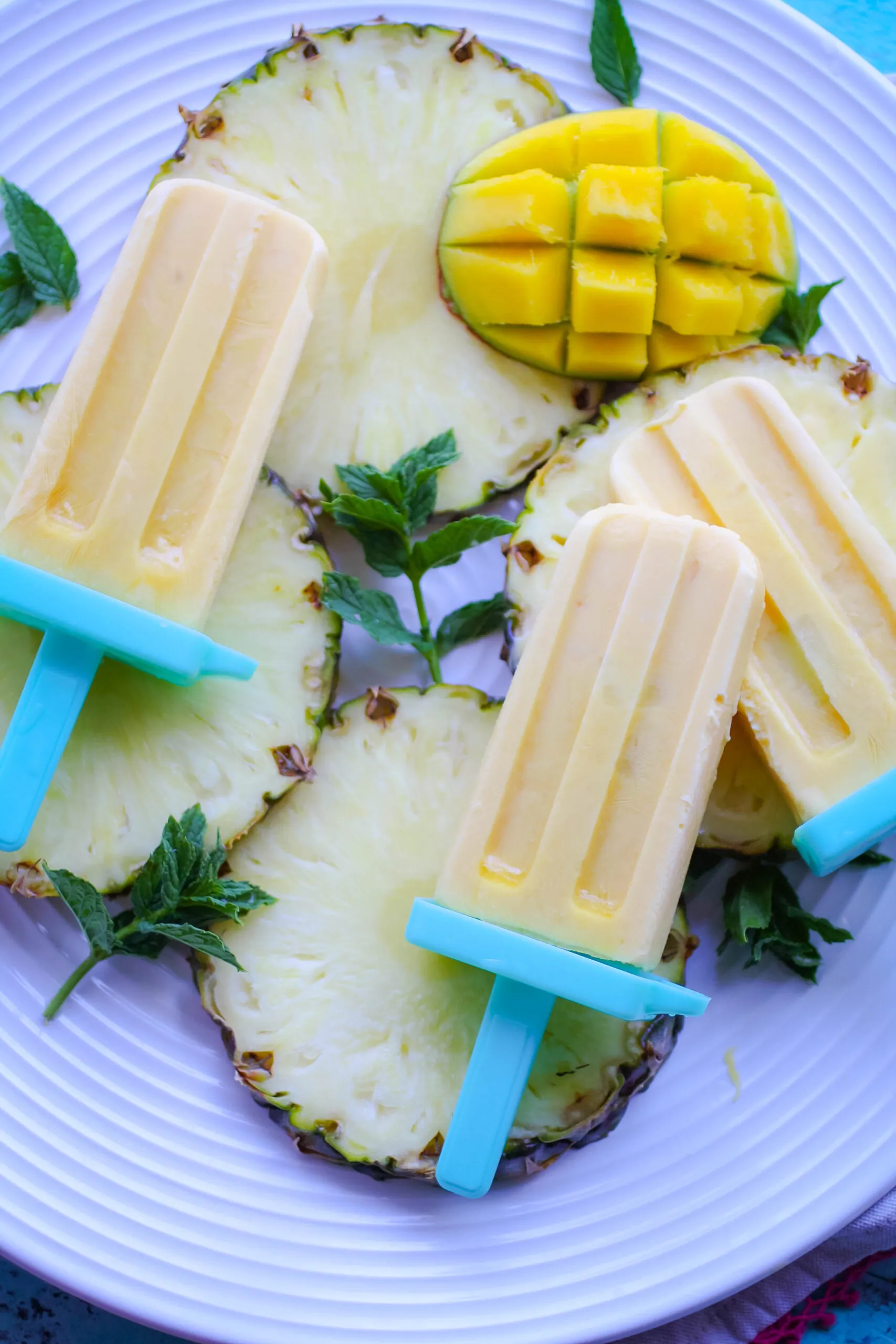 Mango-Pineapple Creamsicles are ideal as a treat to beat the heat!