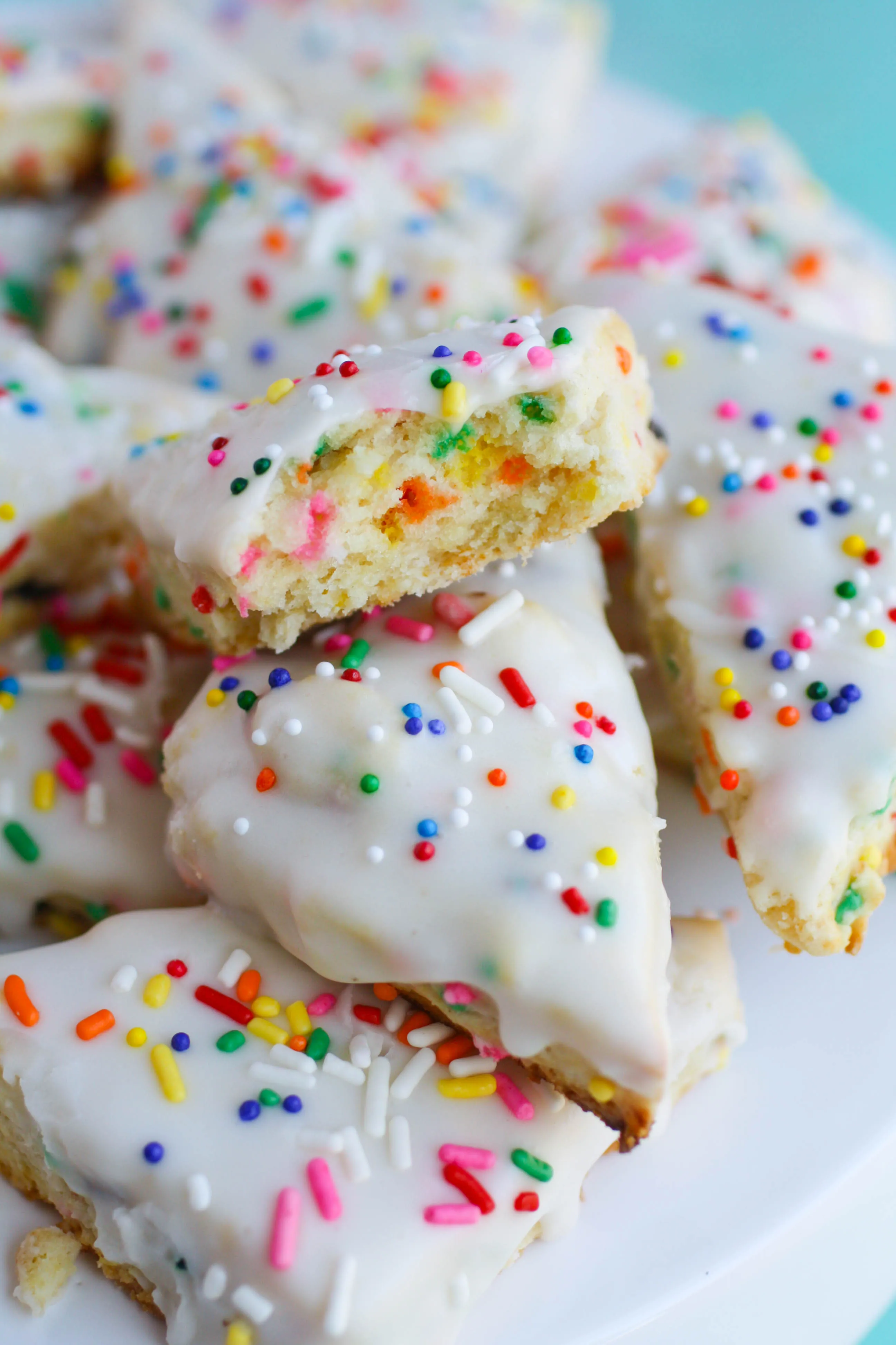 Mini Funfetti Scones are filled inside with sprinkles, and they're all over the tops, too. They are a fun dessert or treat for any occasion.