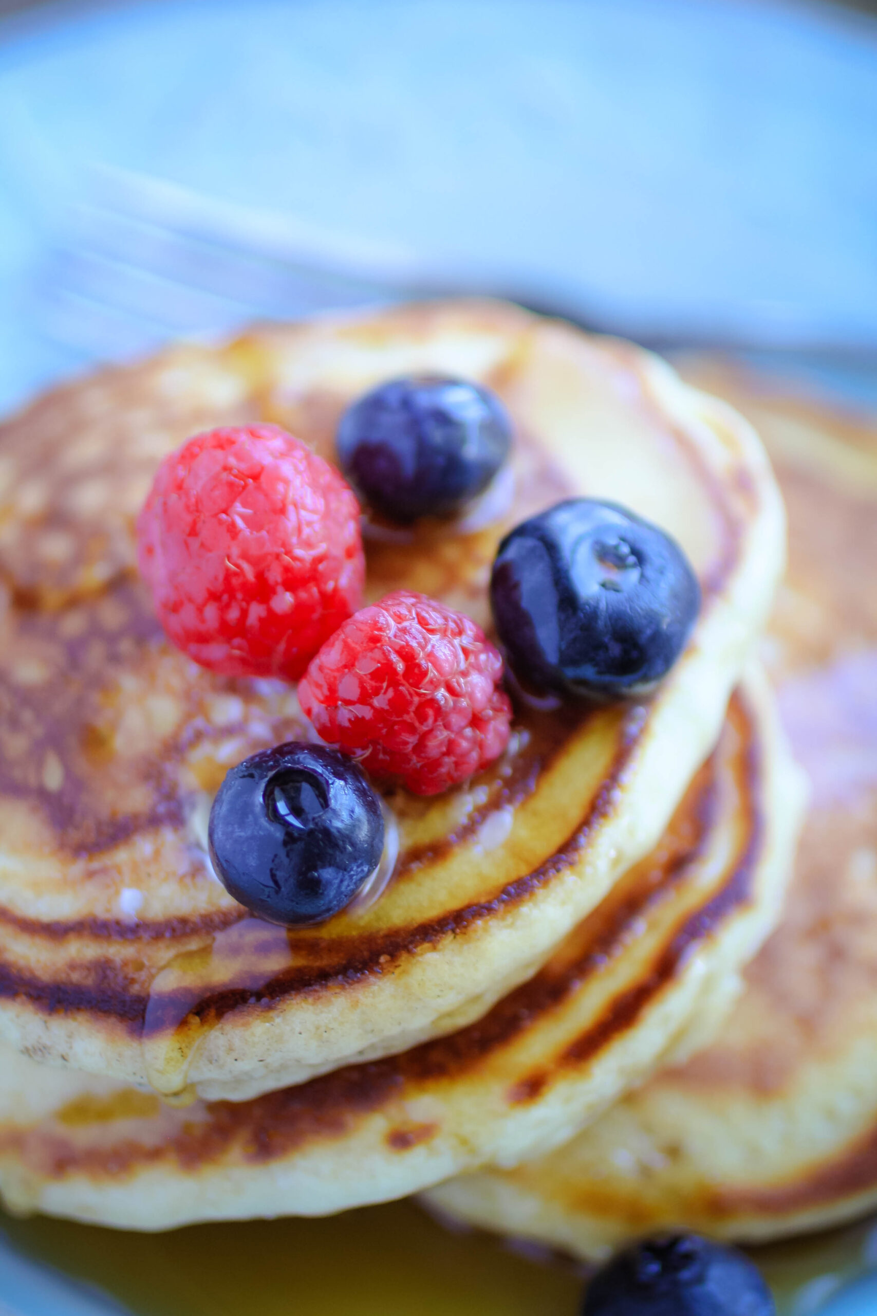 Queen Elizabeth II’s Drop Scones (Scottish Pancakes) covered in syrup and fresh fruit.