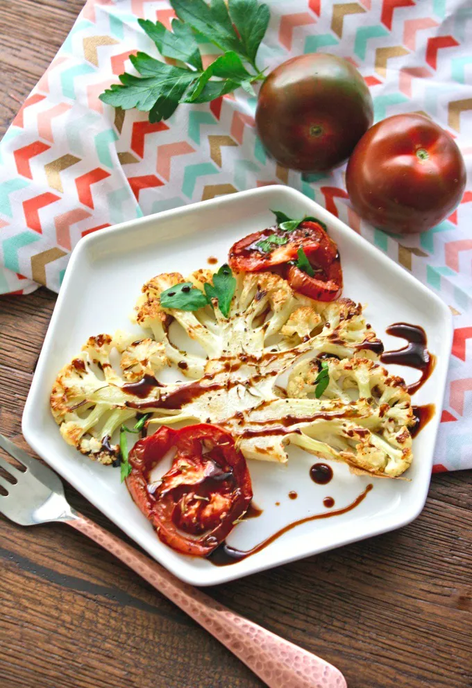Roasted Cauliflower and Tomatoes with Balsamic Glaze is the perfect side this time of year. You'll love the flavor and how filling it is.