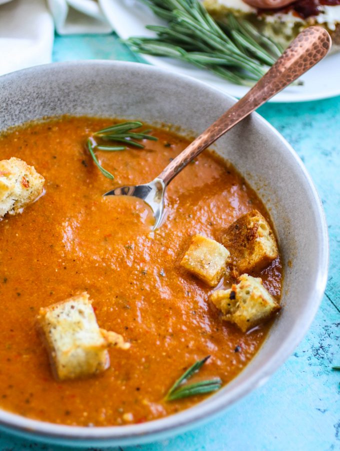 Roasted tomato and vegetable soup with gin drizzle is an ideal soup for the season. Roasted tomato and vegetable soup with gin drizzle is comforting and flavorful for a seasonal dish.