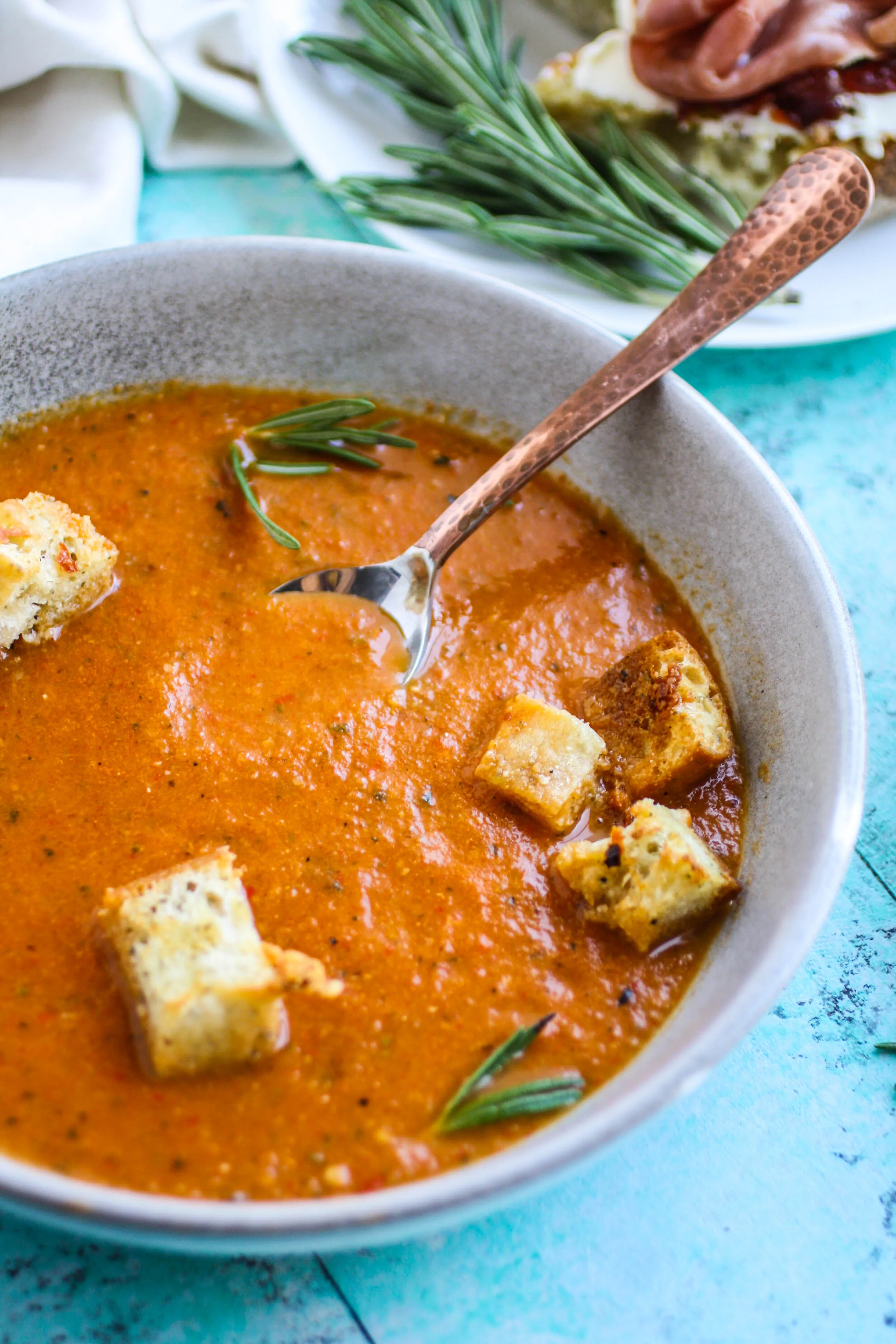 Roasted tomato and vegetable soup with gin drizzle is an ideal soup for the season. Roasted tomato and vegetable soup with gin drizzle is comforting and flavorful for a seasonal dish.