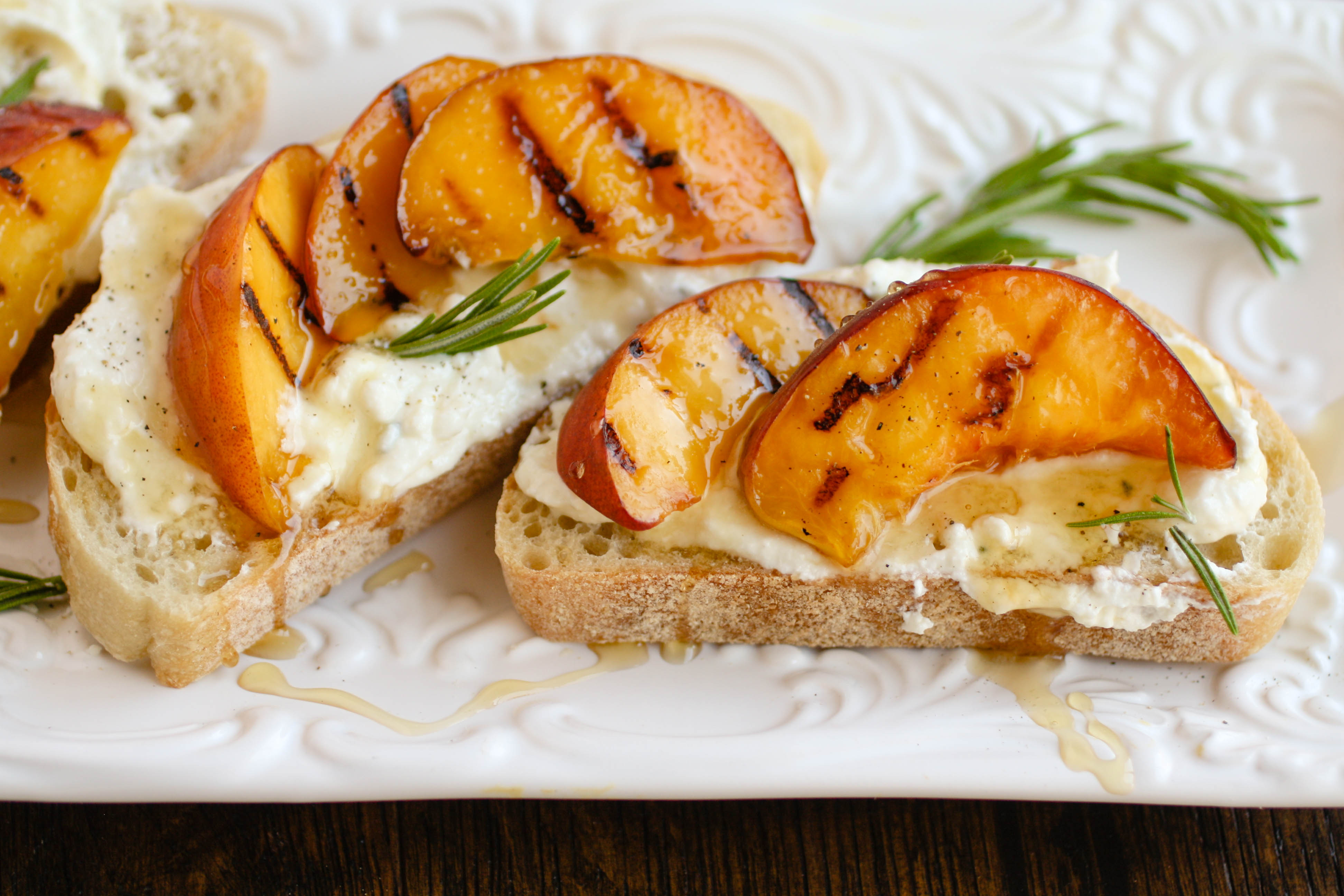 Rosemary Whipped Feta with Grilled Peaches and Honey is the cheese spread you need in your life! This makes a great appetizer for any get together.