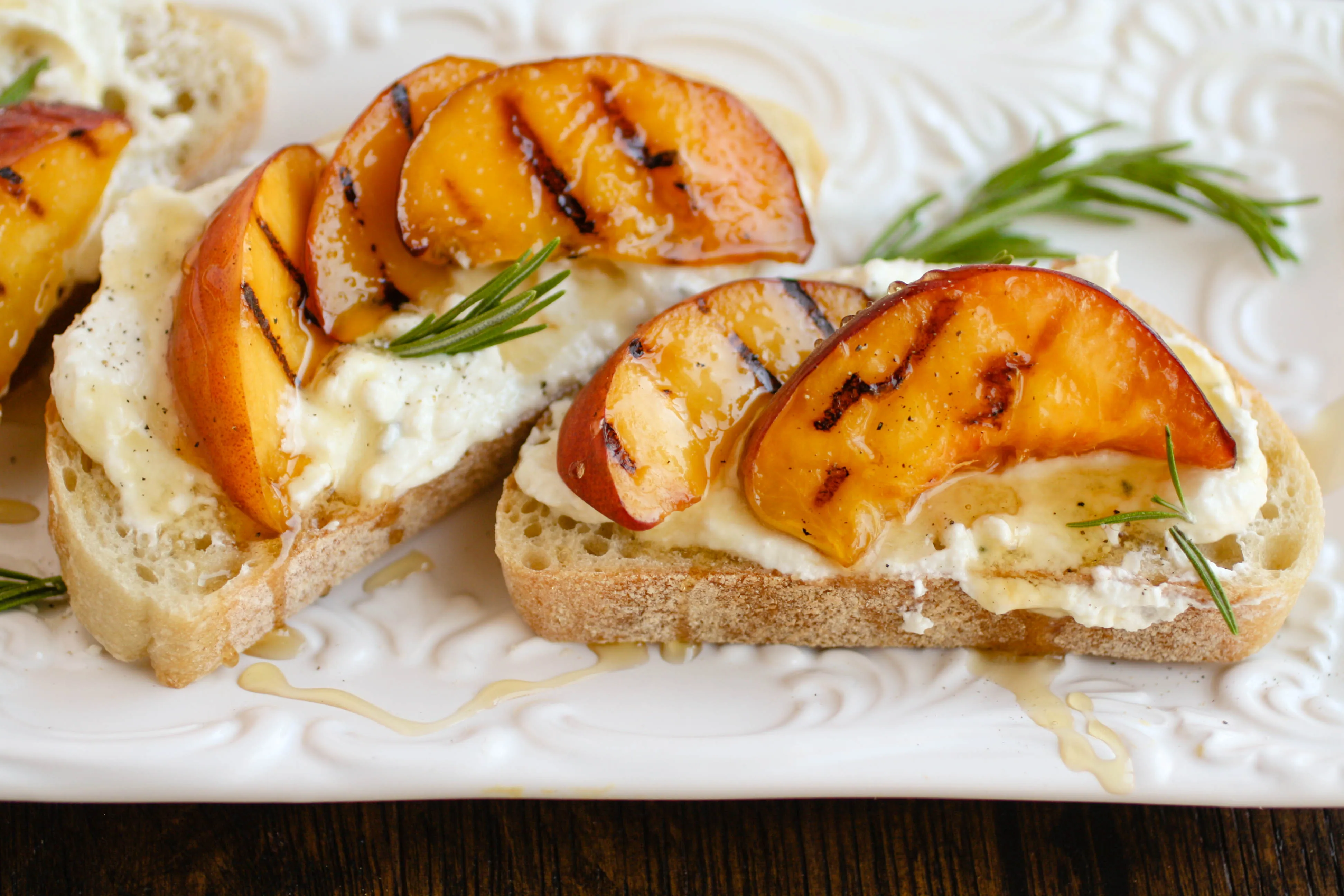 Rosemary Whipped Feta with Grilled Peaches and Honey is the cheese spread you need in your life! This makes a great appetizer for any get together.