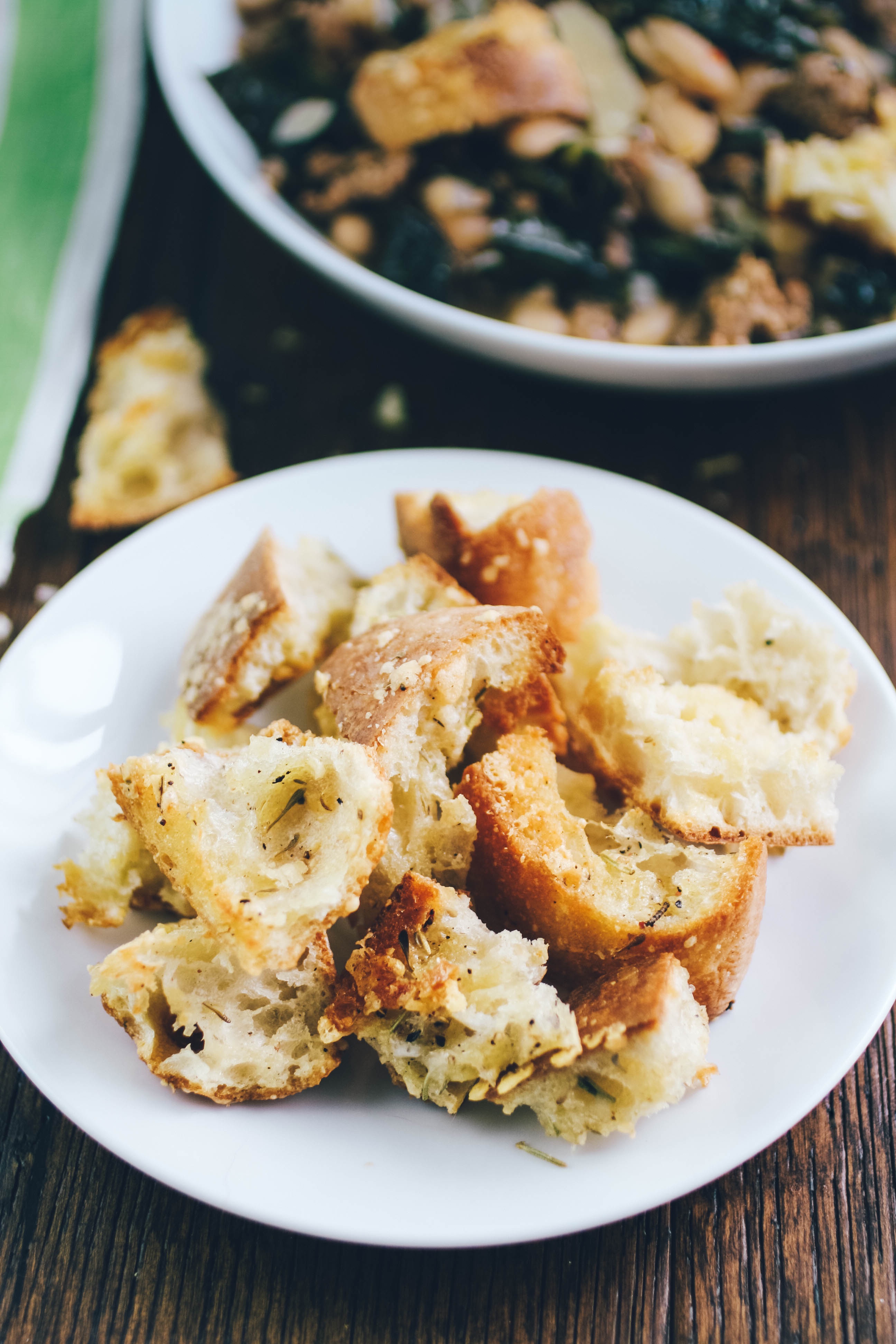 Sausage, Kale, and White Bean Soup with Rosemary-Parmesan Croutons is a tasty and hearty dish. Sausage, Kale, and White Bean Soup with Rosemary-Parmesan Croutons is what you need when you're hungry!