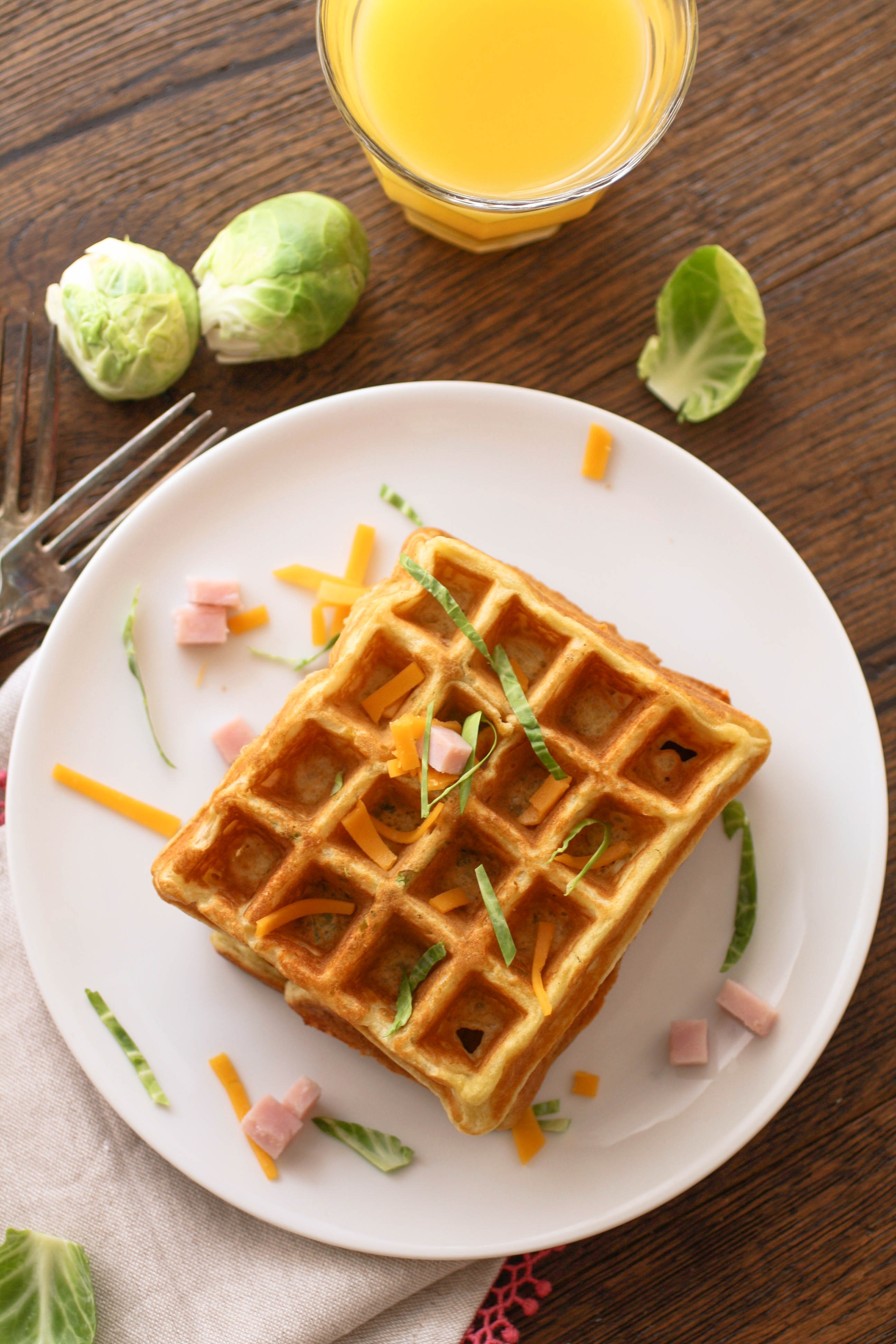 Savory waffles with ham, cheddar, and Brussels sprouts are great for breakfast, lunch, or dinner! They're a great way to use up leftovers, too!