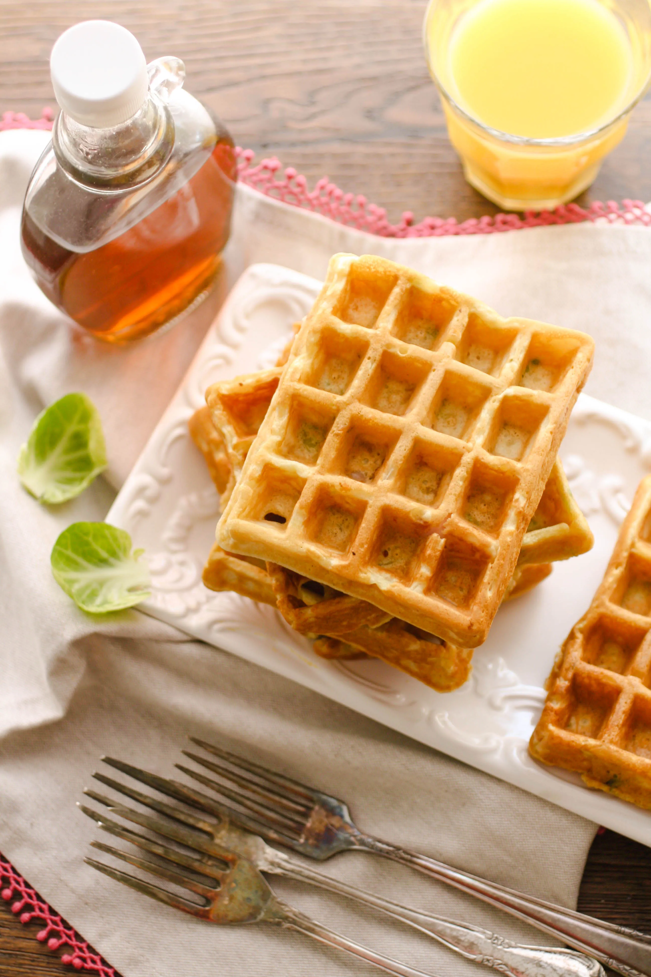 Savory waffles with ham, cheddar, and Brussels sprouts are perfect for any meal! The savory flavors go well with sweet maple syrup!