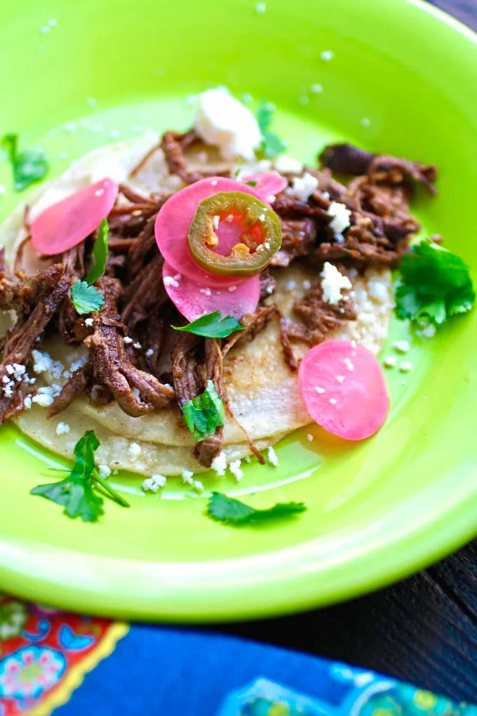 Slow Cooker Beef Carnitas Tacos with Spicy Pickled Radishes is the perfect slow-cooker meal. It's delicious!