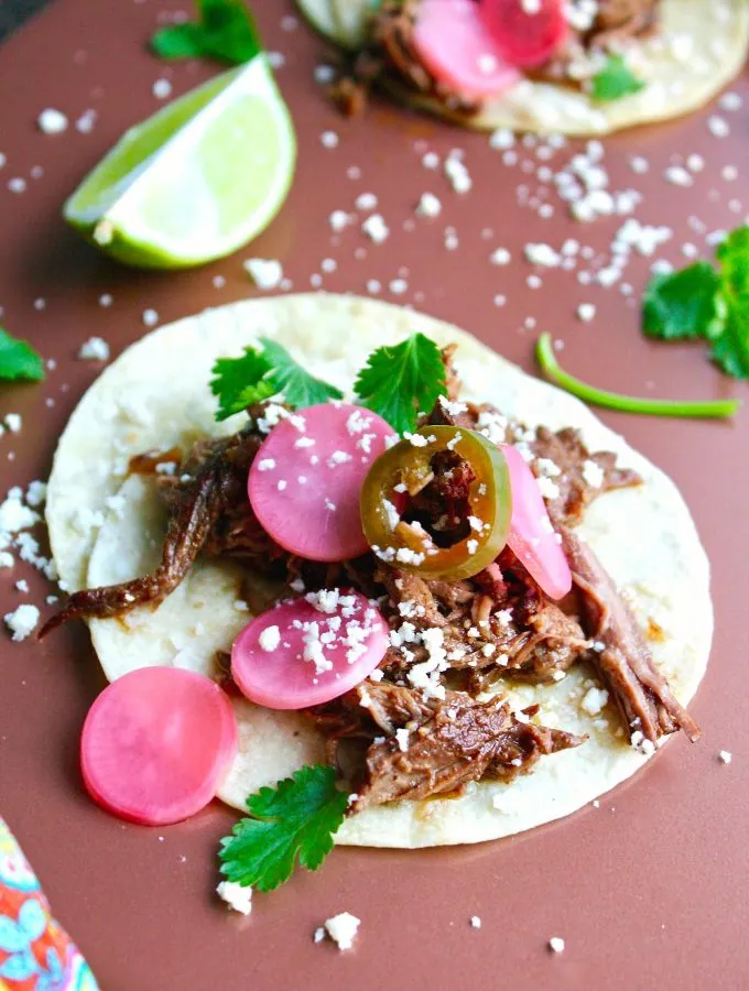 You'll love these Slow Cooker Beef Carnitas Tacos with Spicy Pickled Radishes!