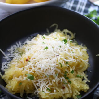 A bowl of Spaghetti Squash with Lemon-Garlic Butter Sauce with Parmesan cheese over the top is a fabulous dish that's easy to make!