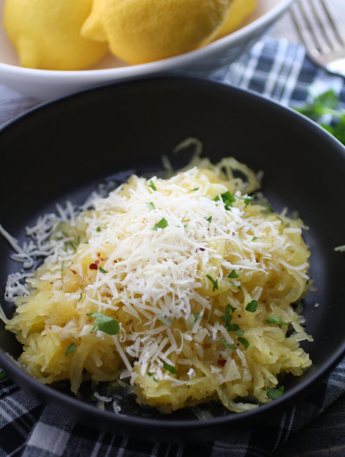 A bowl of Spaghetti Squash with Lemon-Garlic Butter Sauce with Parmesan cheese over the top is a fabulous dish that's easy to make!