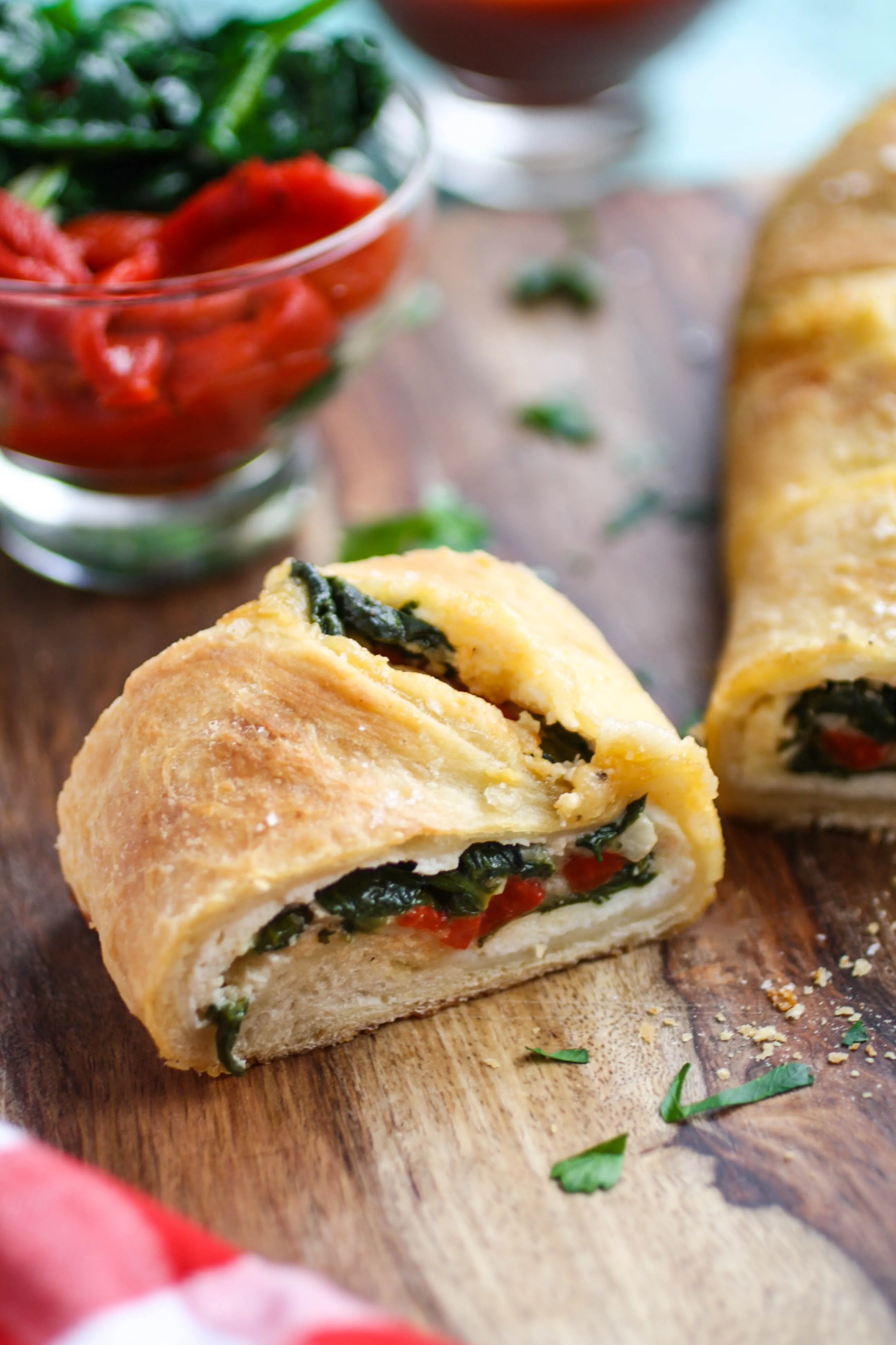 Spinach and Roasted Red Pepper Stromboli is a wonderful dish to serve any night of the week. Stromboli is like pizza, but rolled up and baked!