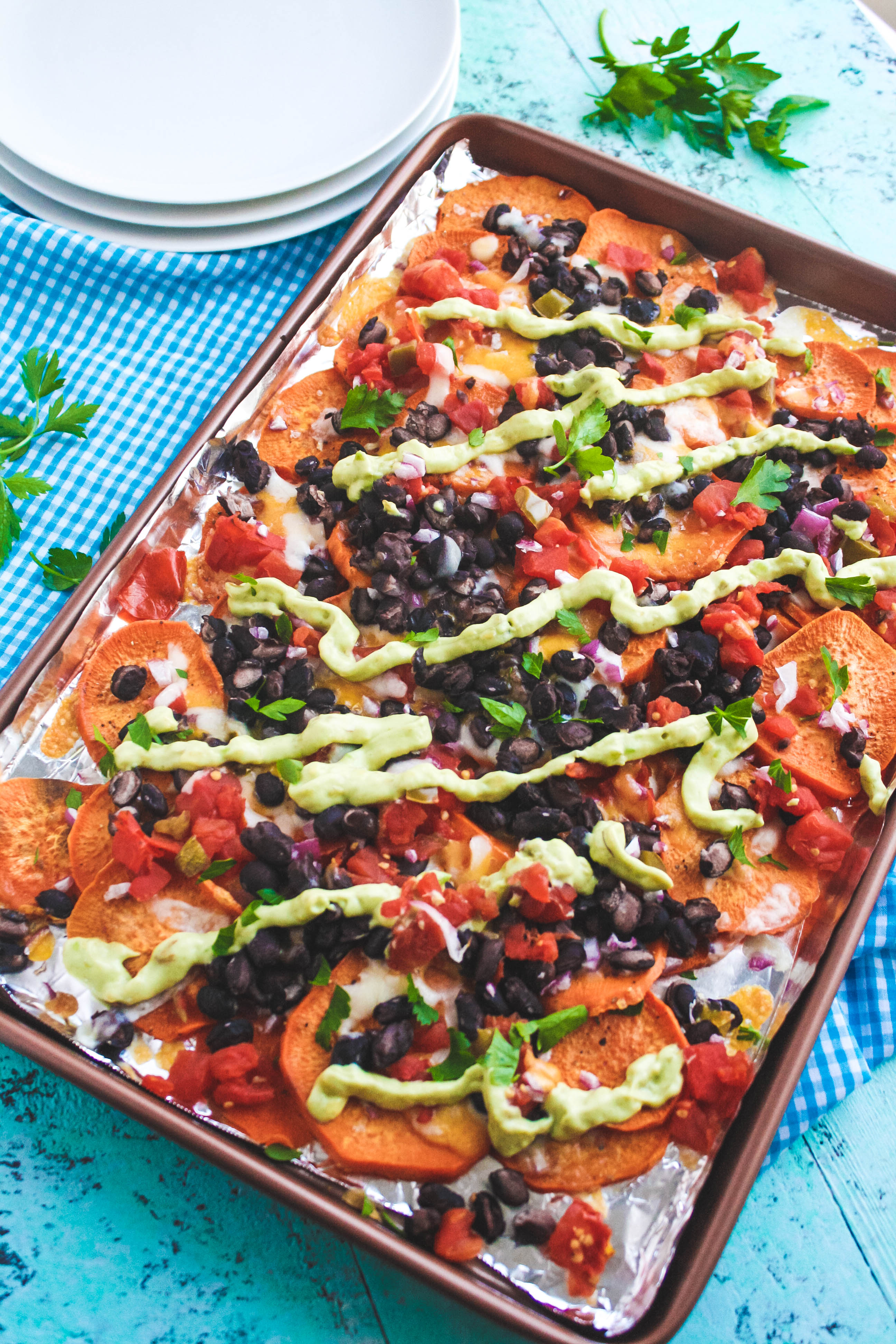 Sweet Potato Nachos with Avocado Crema are delightful as a non-traditional snack. You'll love these Sweet Potato Nachos with Avocado Crema!