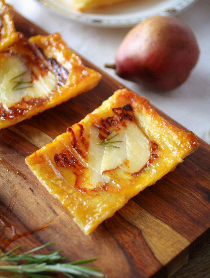 Looking down on a rectangle of golden, flaky tart with pear topping