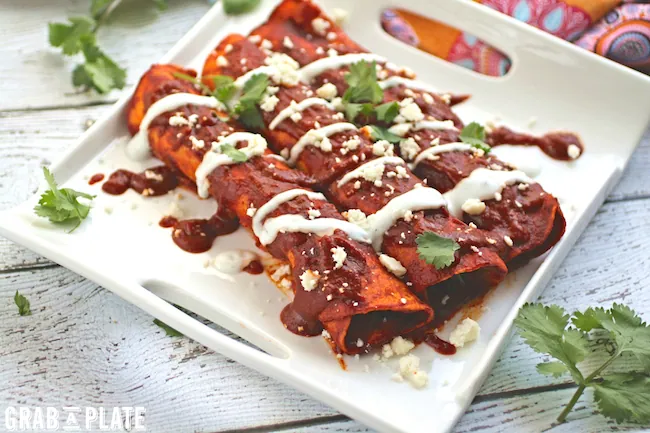Mushroom and Kale Enchiladas with Red Sauce make a pretty presentation at the dinner table. You'll love this Mexican favorite!