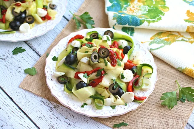 Serve a delicious meal with a pretty presentation: Chilled Zucchini Ribbon "Pasta" with Black Olives, Roasted Red Peppers and Mozzarella